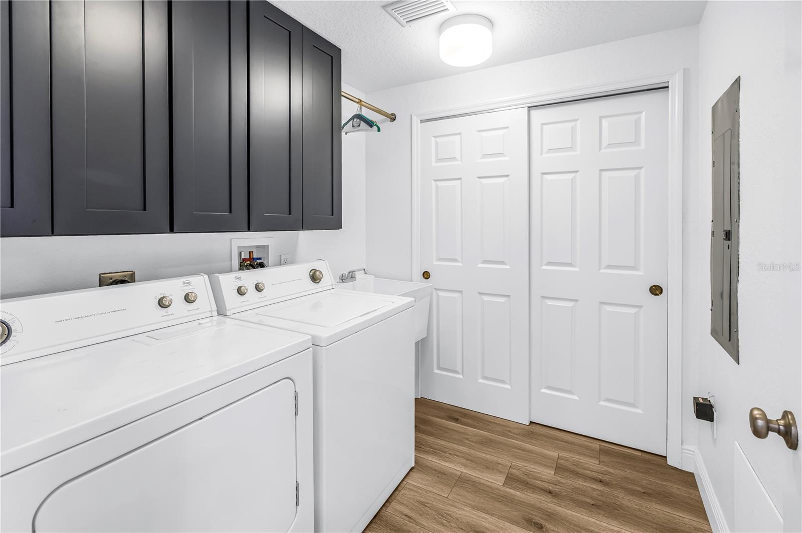 Inside Laundry Room w/ Wash sink & storage