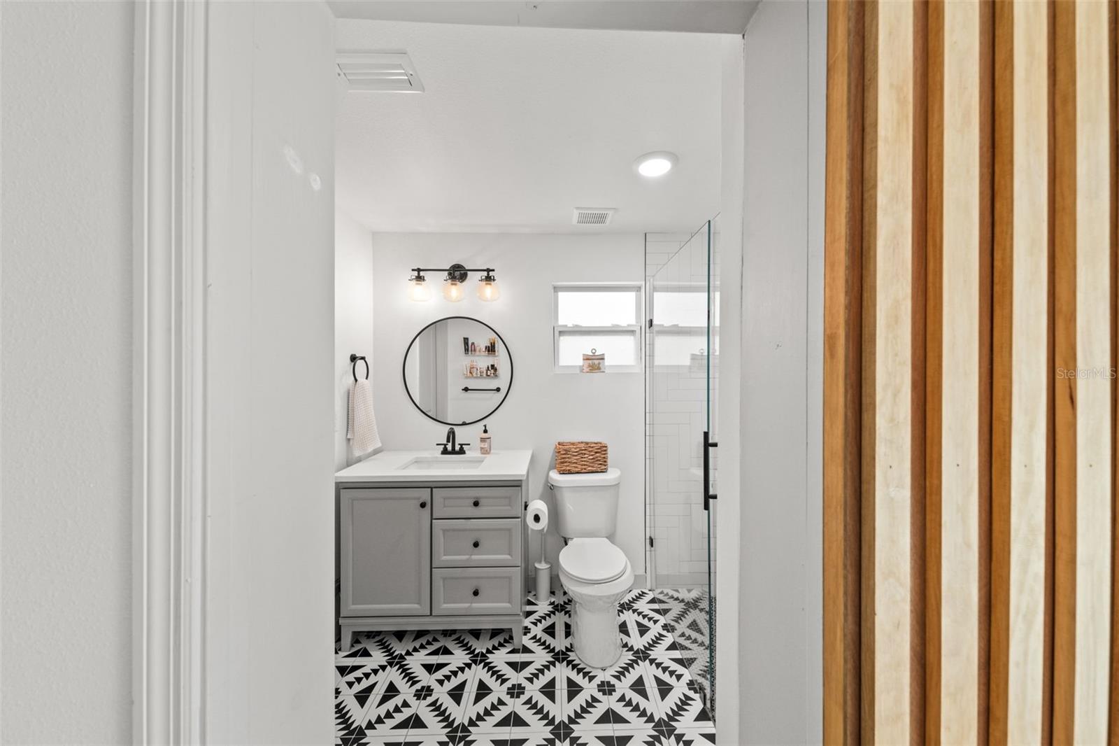 Another custom barn door leads to the bathroom