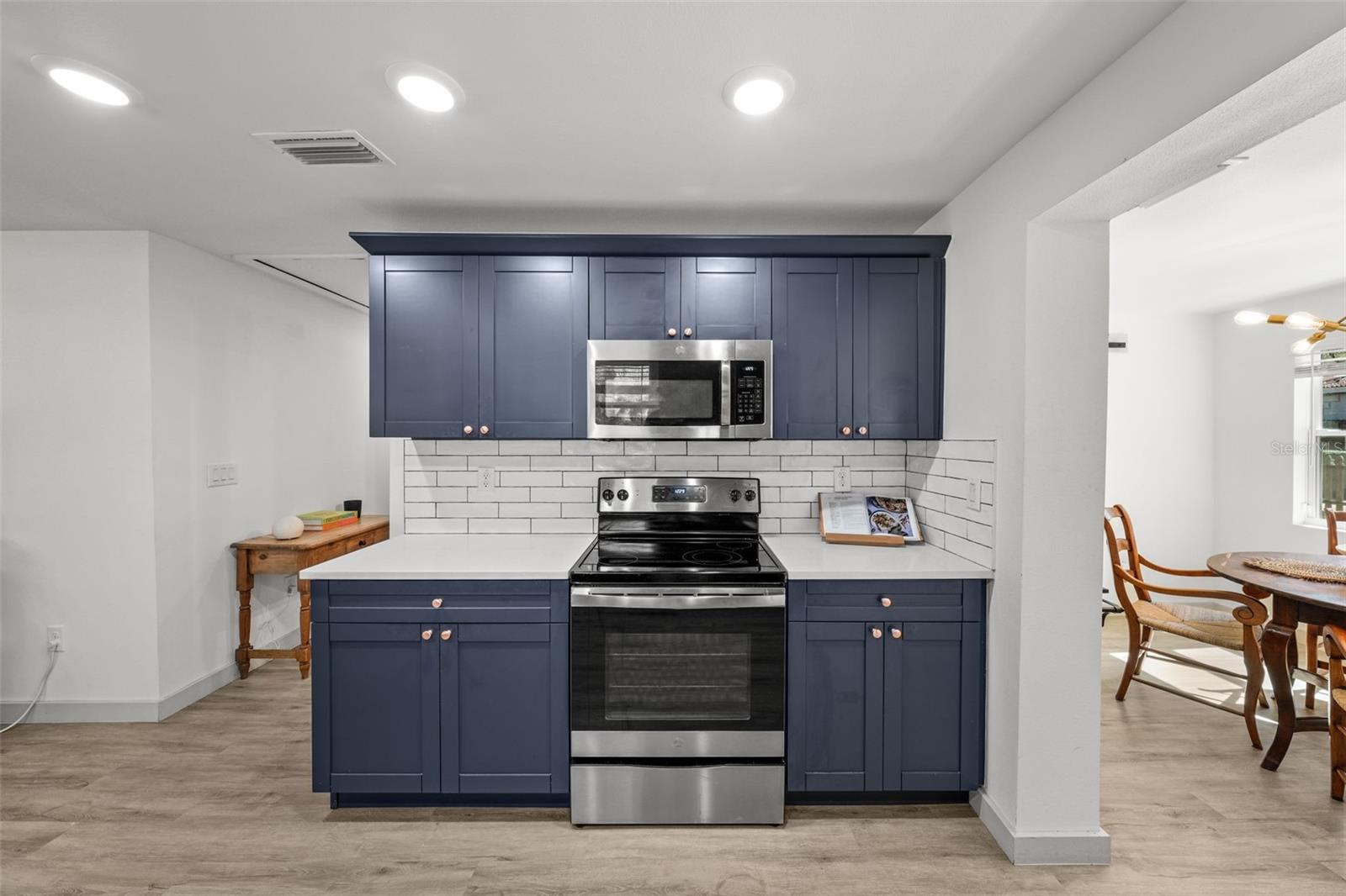 On-trend cabinets, quartz counter tops and stainless steel appliances