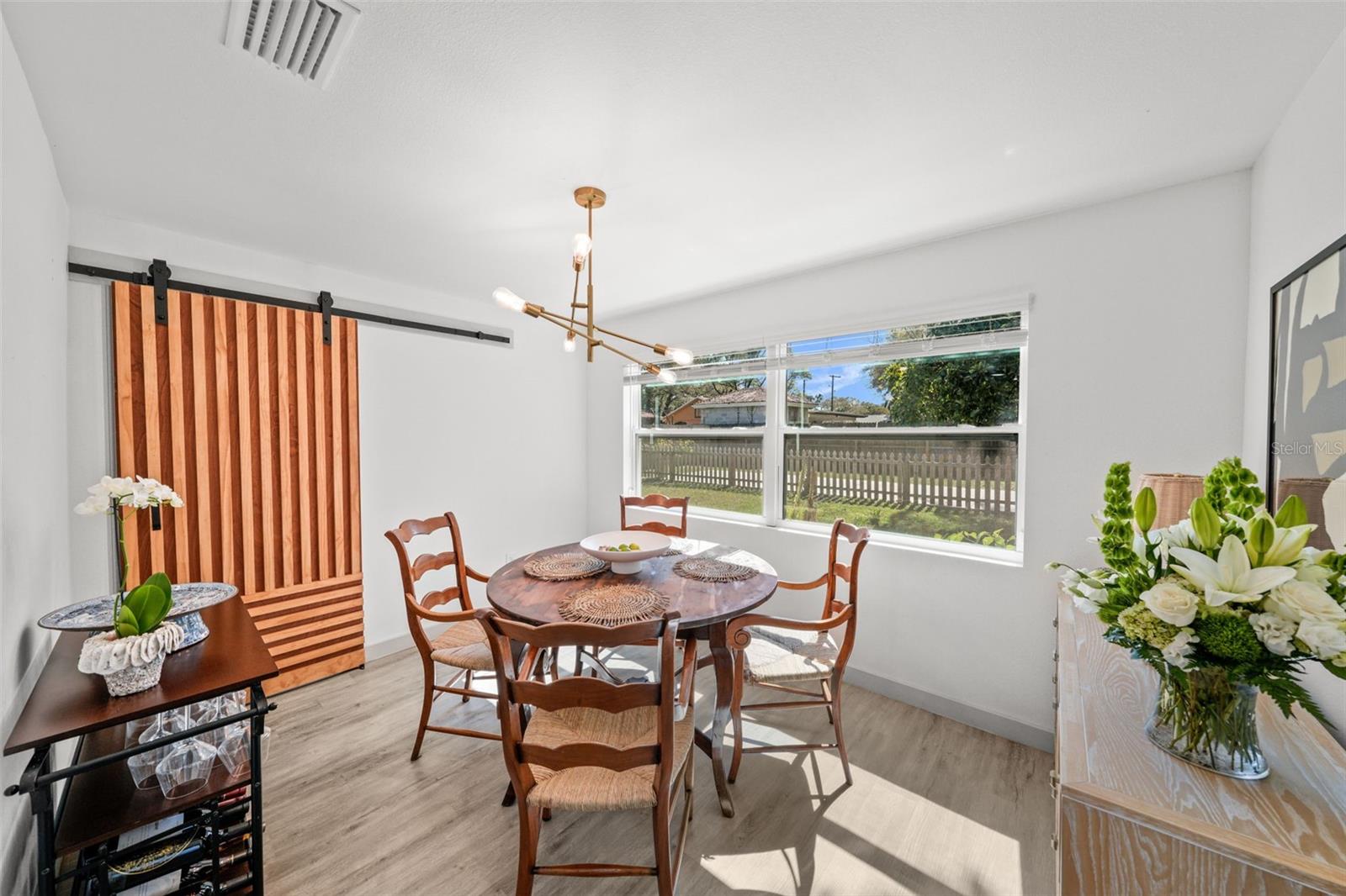 Custom barn door separates dining room from pantry and