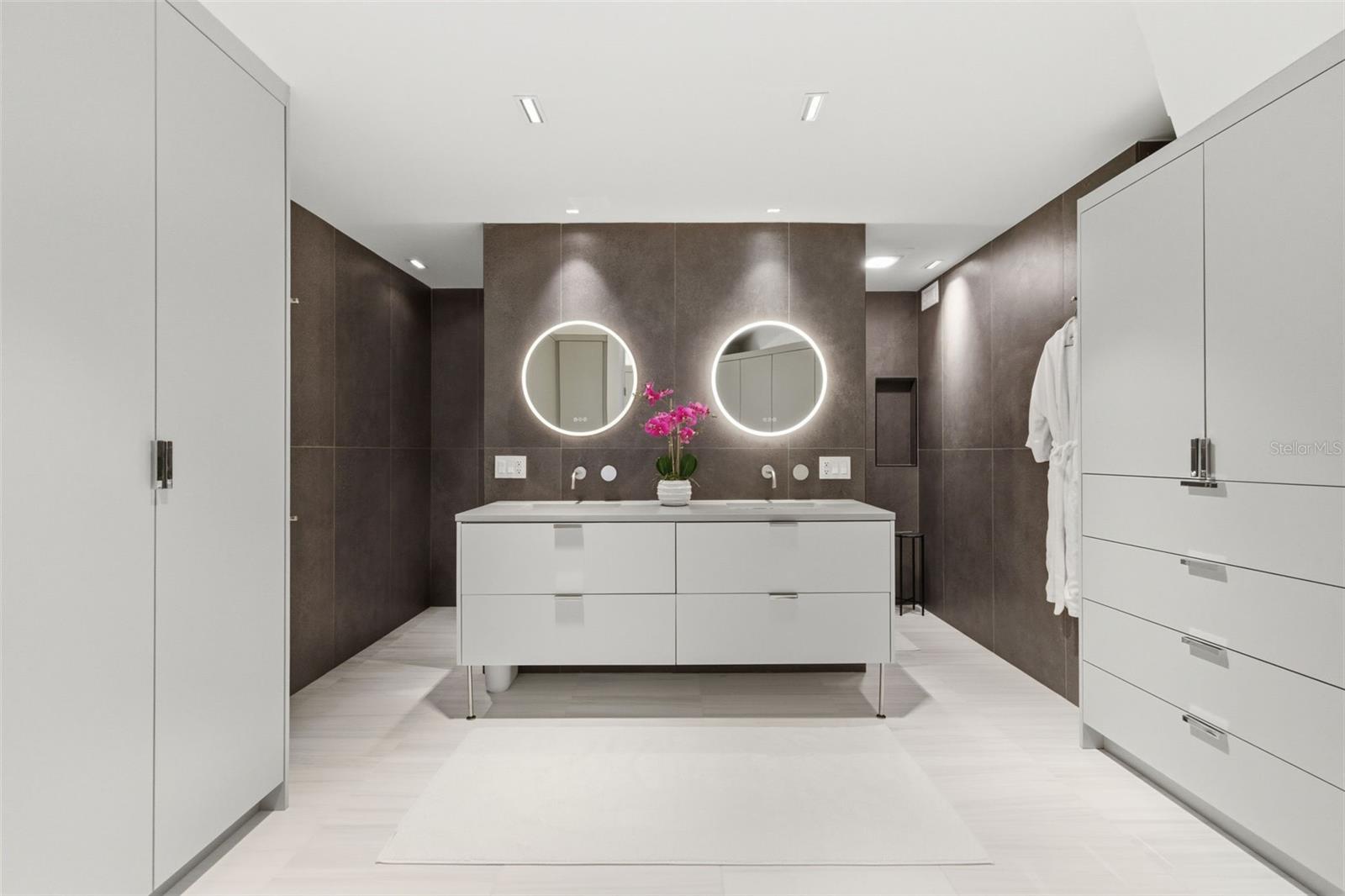 Exquisite primary bath with built in closets.