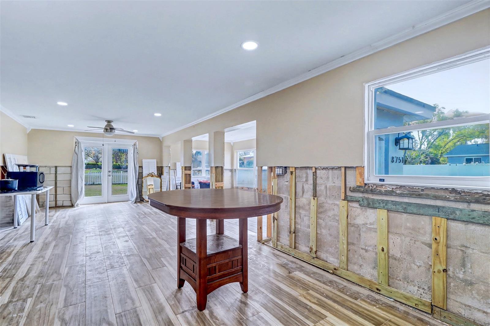 Seller intended to make a large island where the table is and make a round end so it could be a table with several stools around for casual sitting