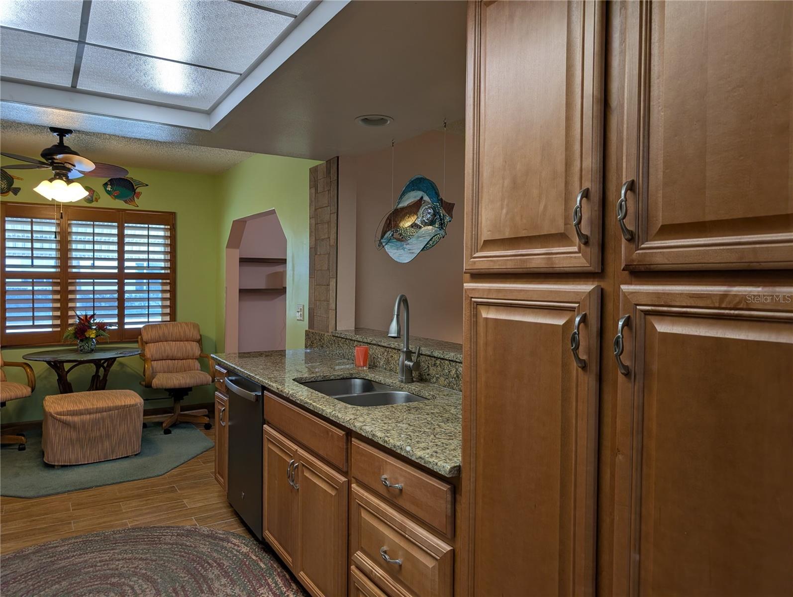 Dishwasher was installed 2025.  Two pantries...one on each side provide great storage.  Pass thru window to Florida room is very convenient.  Deep stainless sink w/pot faucet for easier cleanup.