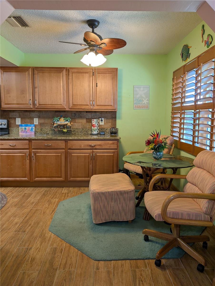 Traditional eat in kitchen area is now a casual dining area for two/three to enjoy sitting by the window and offers much more cabinetry/counterspace.