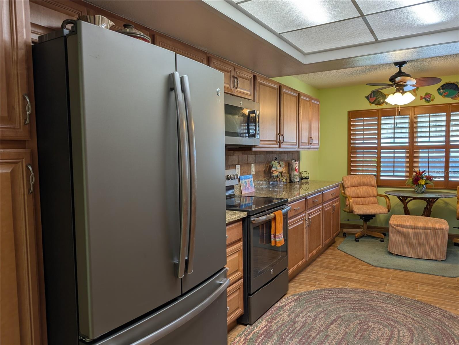 Closer view of the GE matching fingerprint resistant slate appliances w/satin finish handles. 1st Pantry is to left of frig.