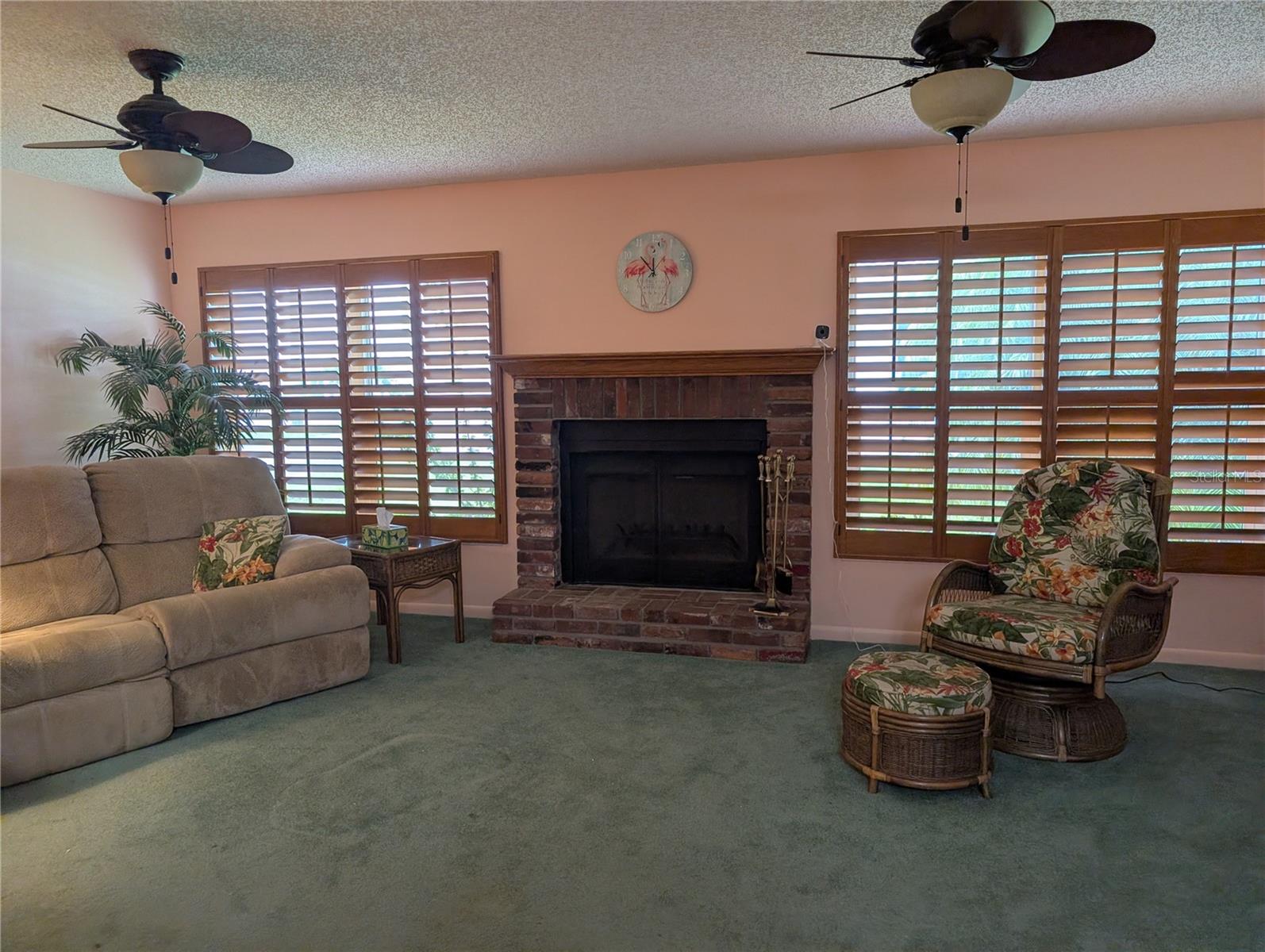 View of both windows.  Features also include the tropical fans and Honey oak plantation shutters.