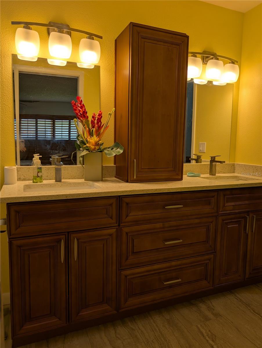 Primary ensuite bathroom was totally remodeled 2020. It features Honey oak cabinets, stone countertops w/undermount sinks, brushed nickel hardware and beautiful tile flooring to match shower tile.