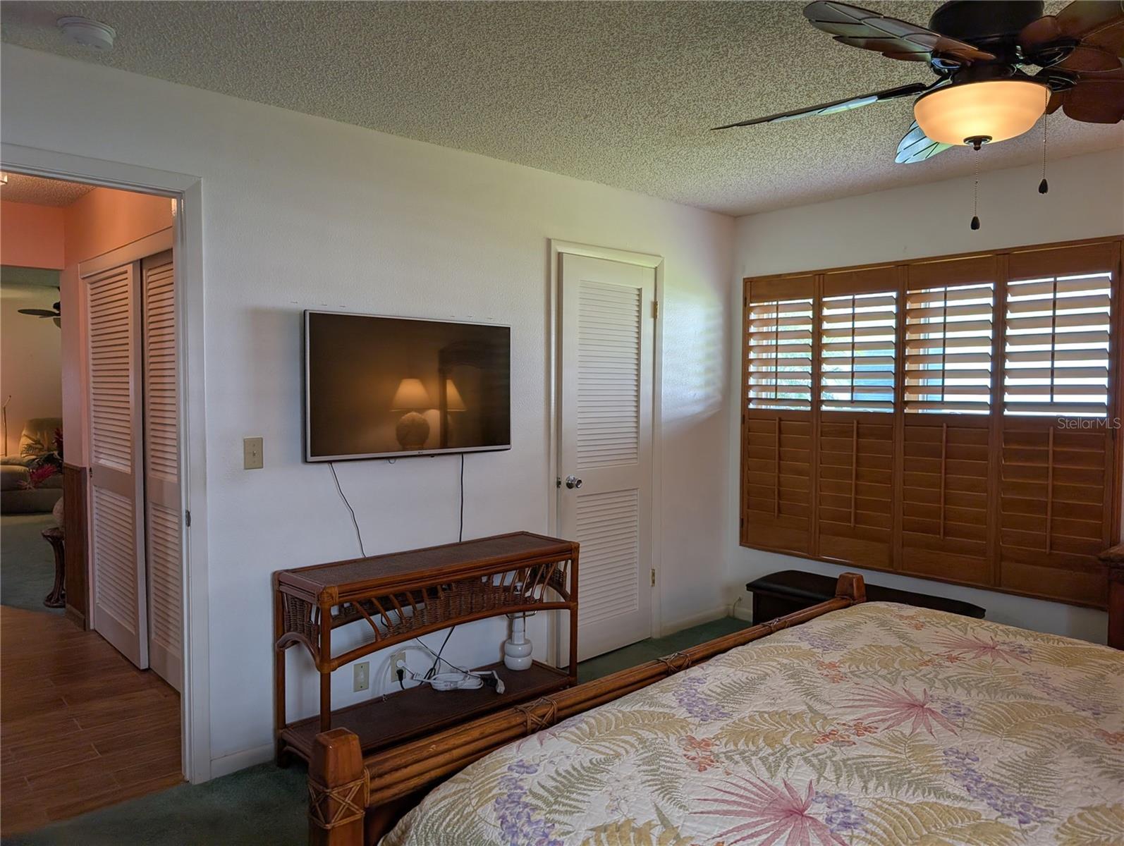 View of walk-in closet to right and hallway entry to left.  Hall closet is visible.  Hallway leads to dining and Florida room.