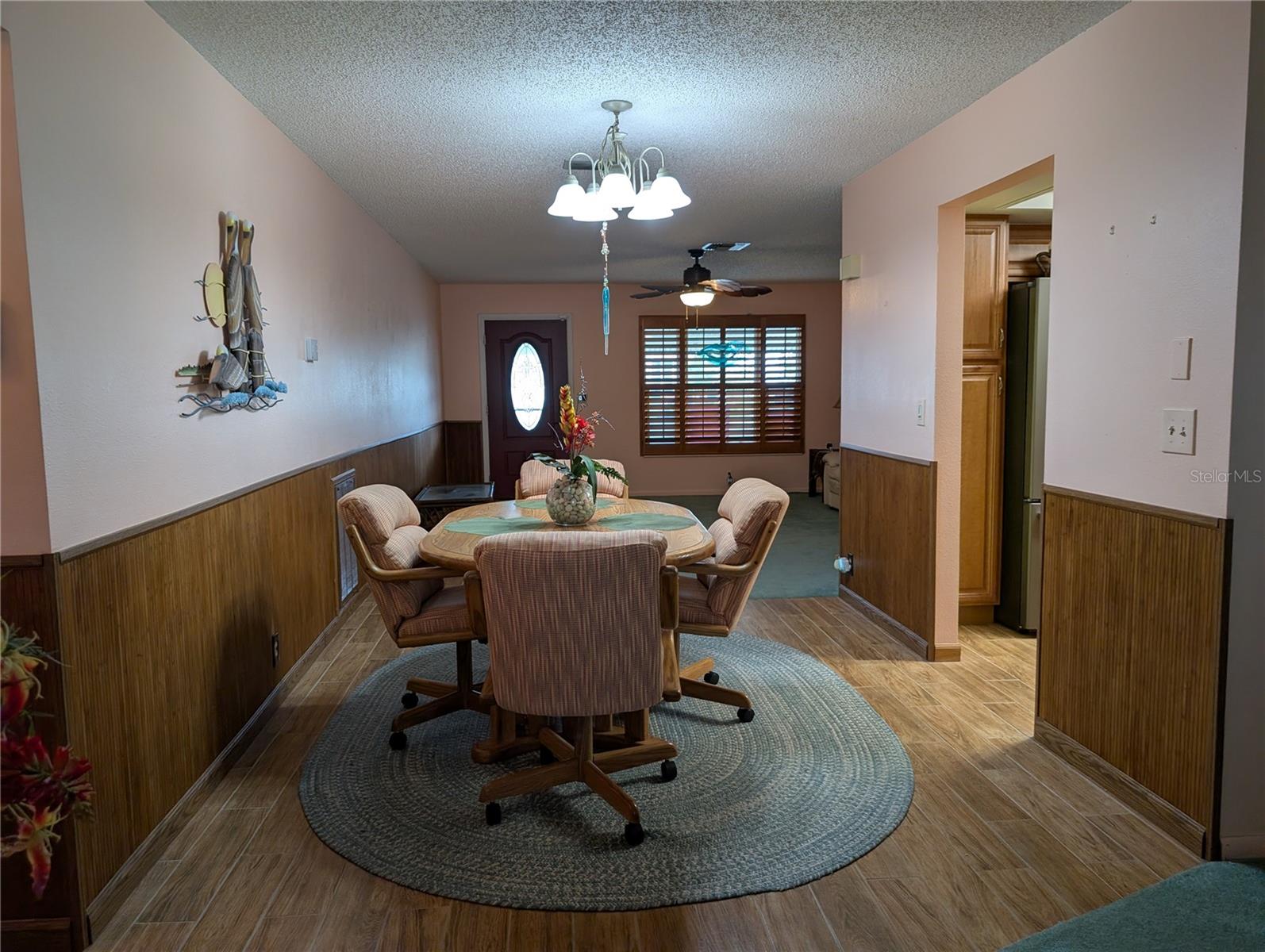 Leaving interior tour via hallway to front door.  Kitchen on right.