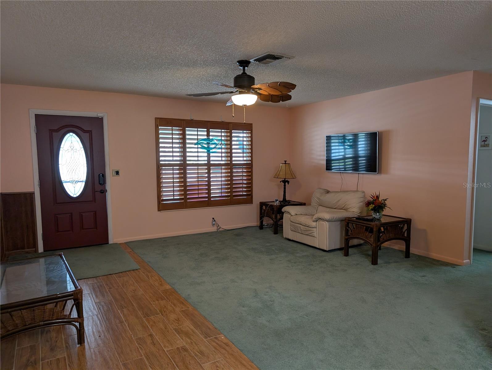 View of living room to front entry as we leave. LET'S TOUR THE EXTERIOR NEXT.