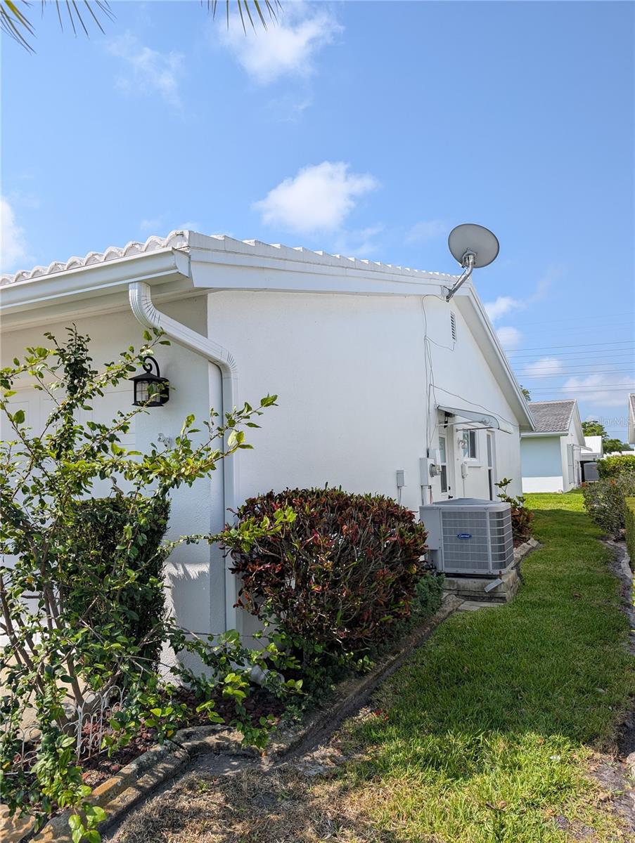 Side of home has 3 ton Carrier HVAC system (2018) and side garage door entry.  Satellite dish is not in use.