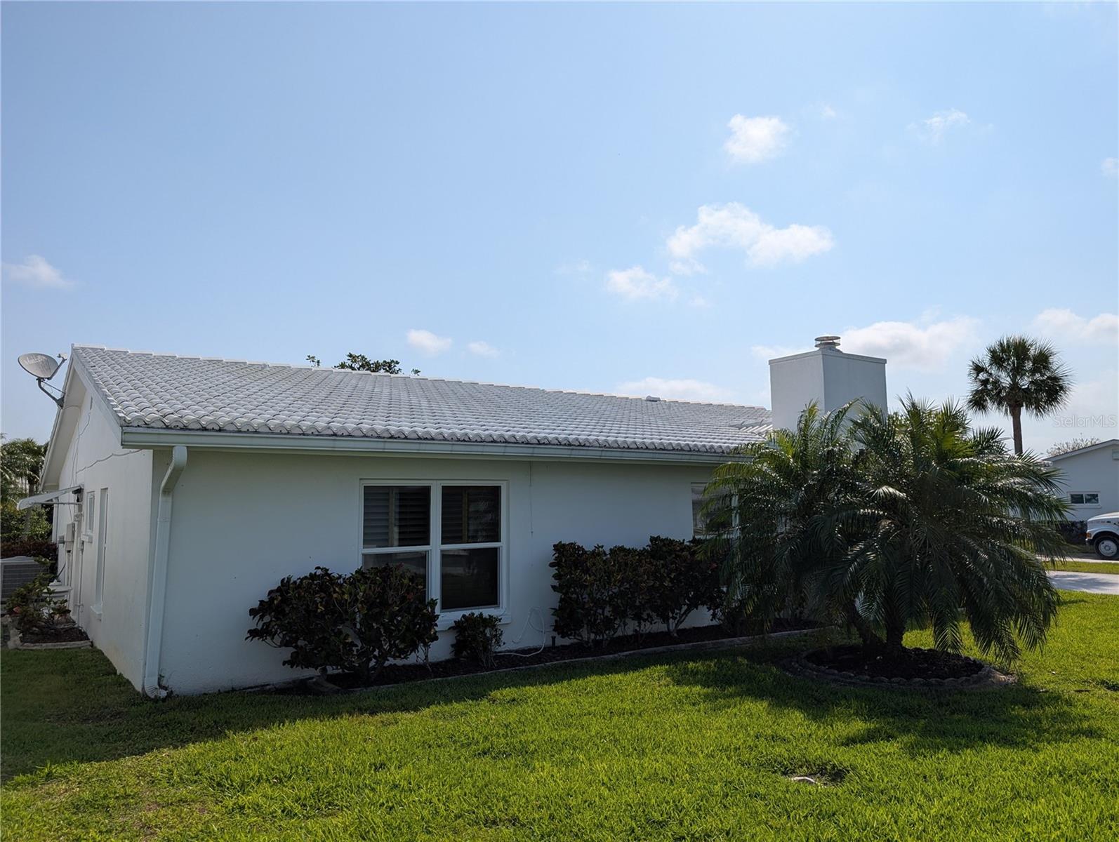Exterior rear view of Florida room and primary bedroom.  Exterior of home is painted by the association on a scheduled basis.