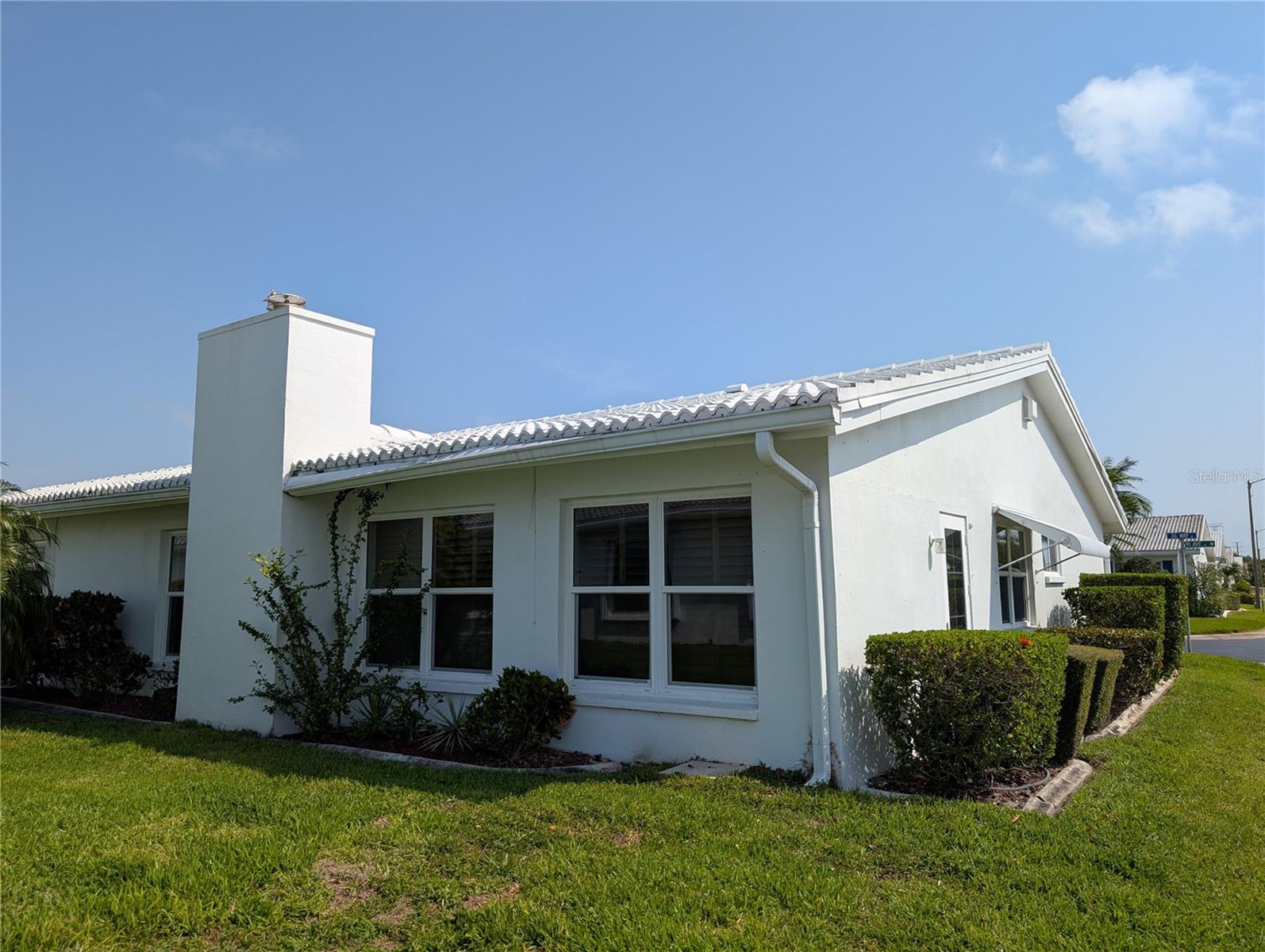 View of Florida room (fireplace) and Bonus room.  Side yard of corner lot.  Door from Bonus room on right (not in use).