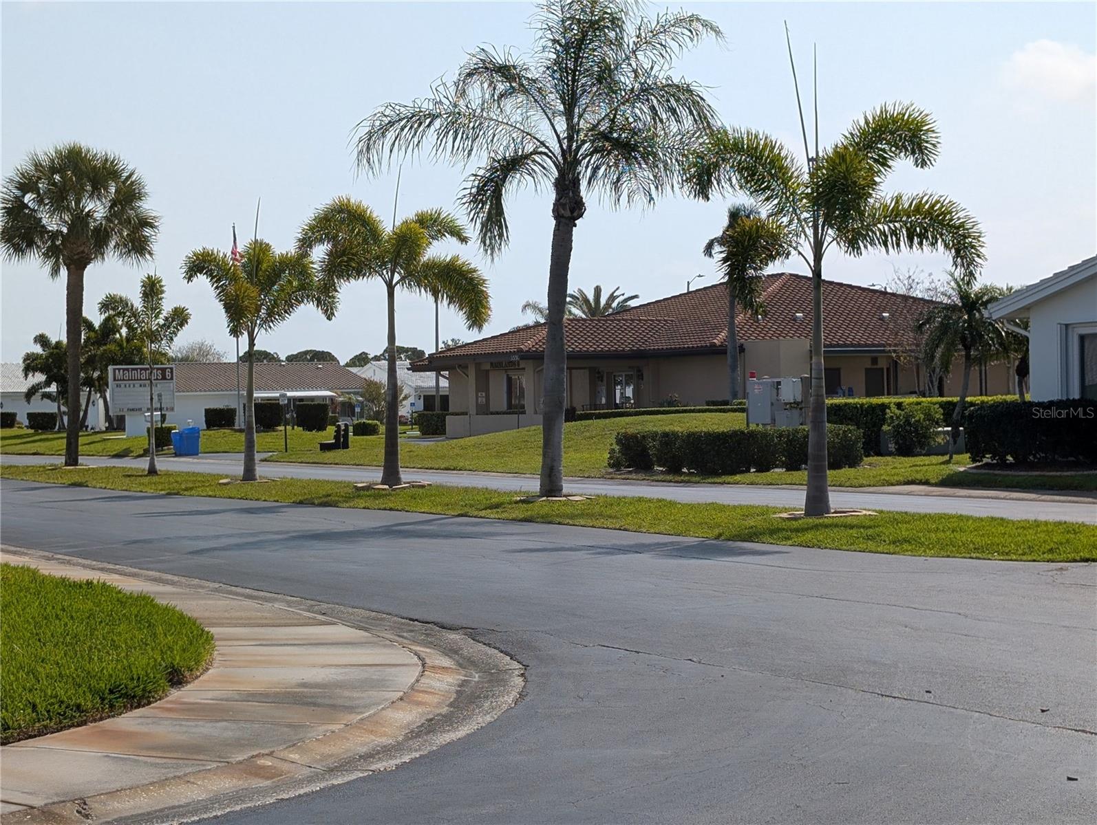 View from front yard to clubhouse across the street.  Conveniently located... just a short hop, skip or jump to any of the events or activities.