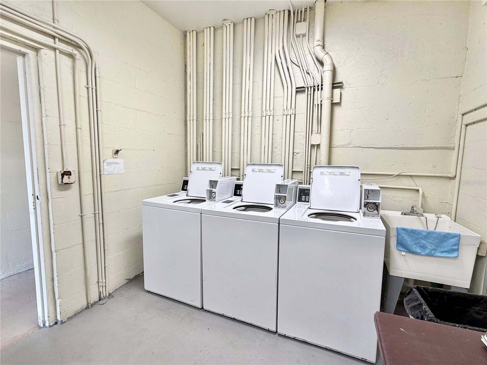 Laundry room with brand new dryers.