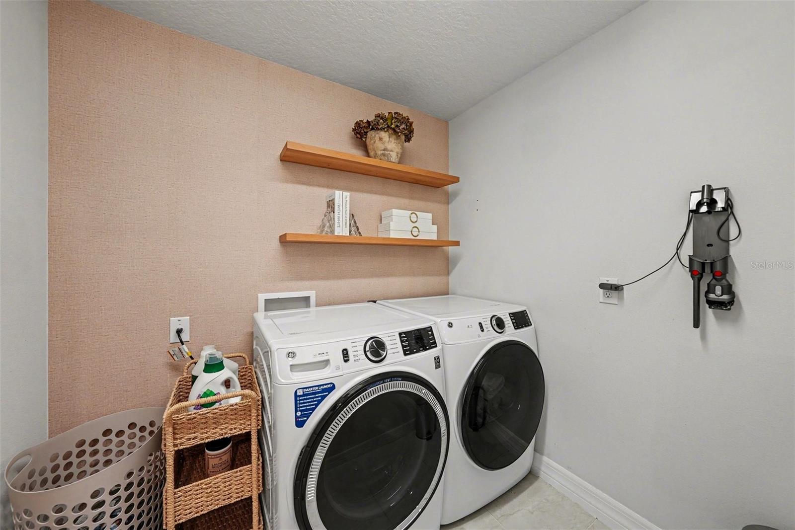Spacious laundry room with floating shelves!