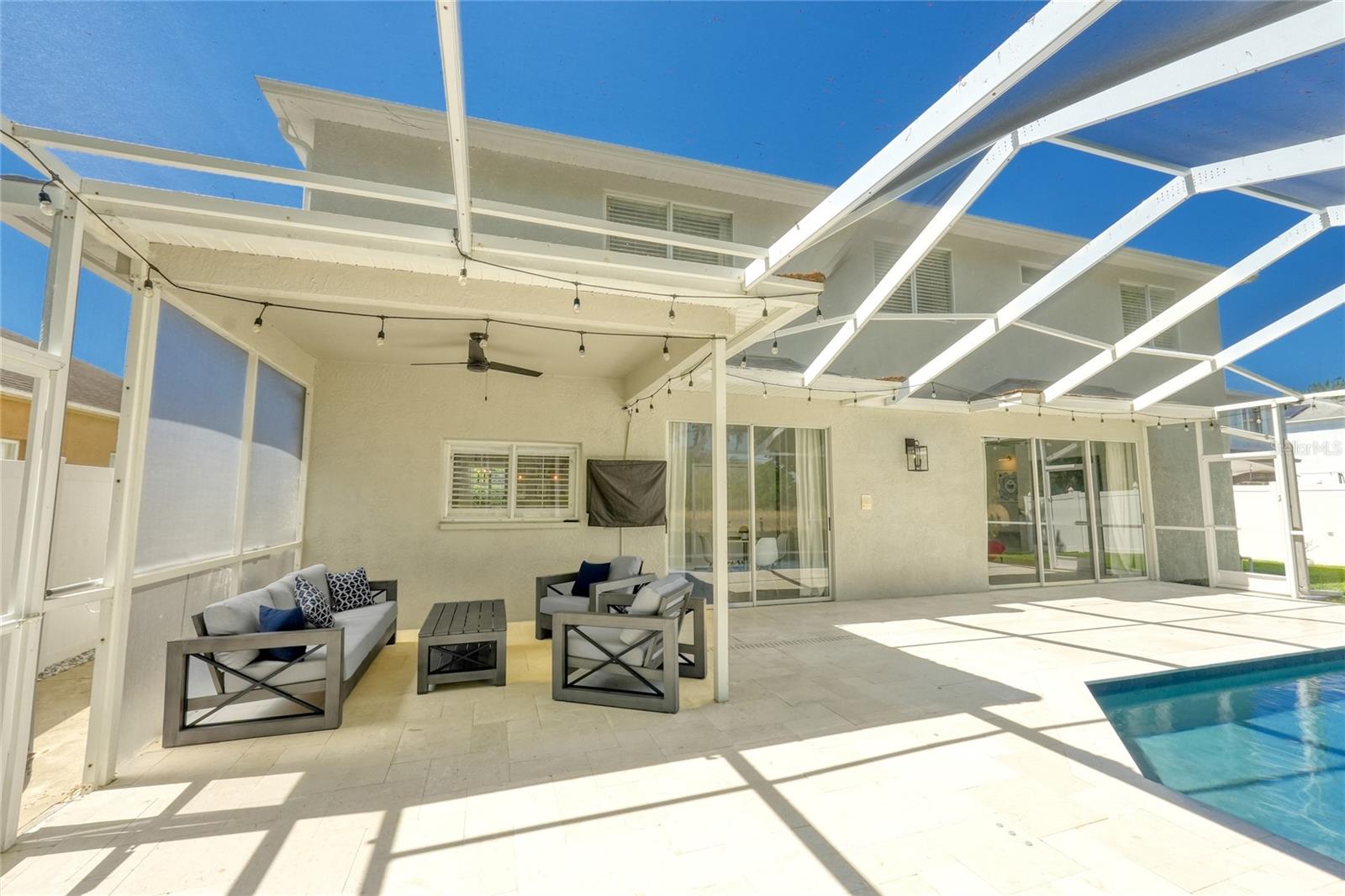 View of the back of the home from the covered and screened in Lanai/Pool area