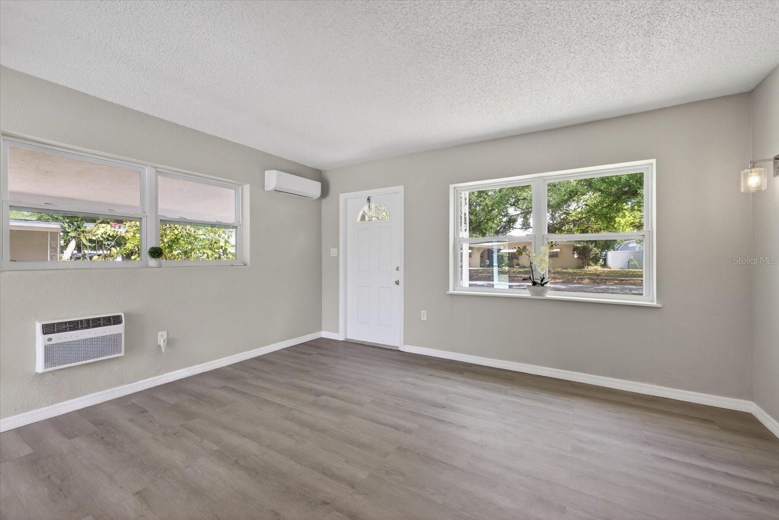 Front door in living room with mini split