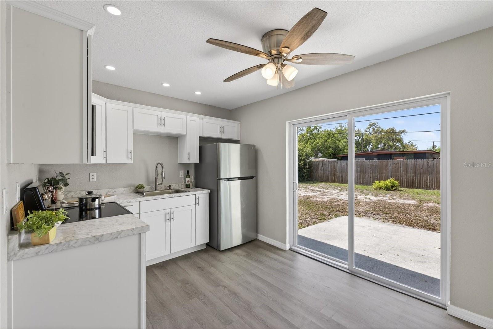 Bright kitchen with sliding door to backyard patio