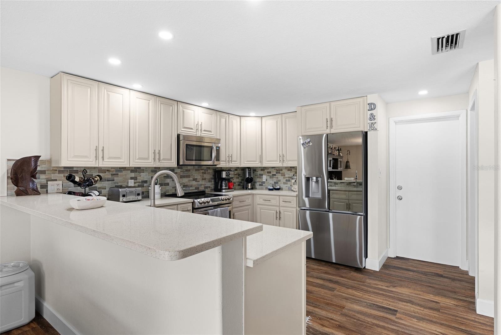 Quartz counters and ample storage in the kitchen