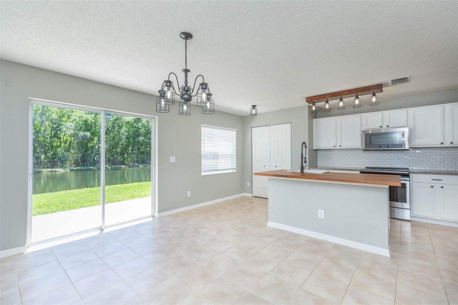 Living/kitchen room overlooking pond views