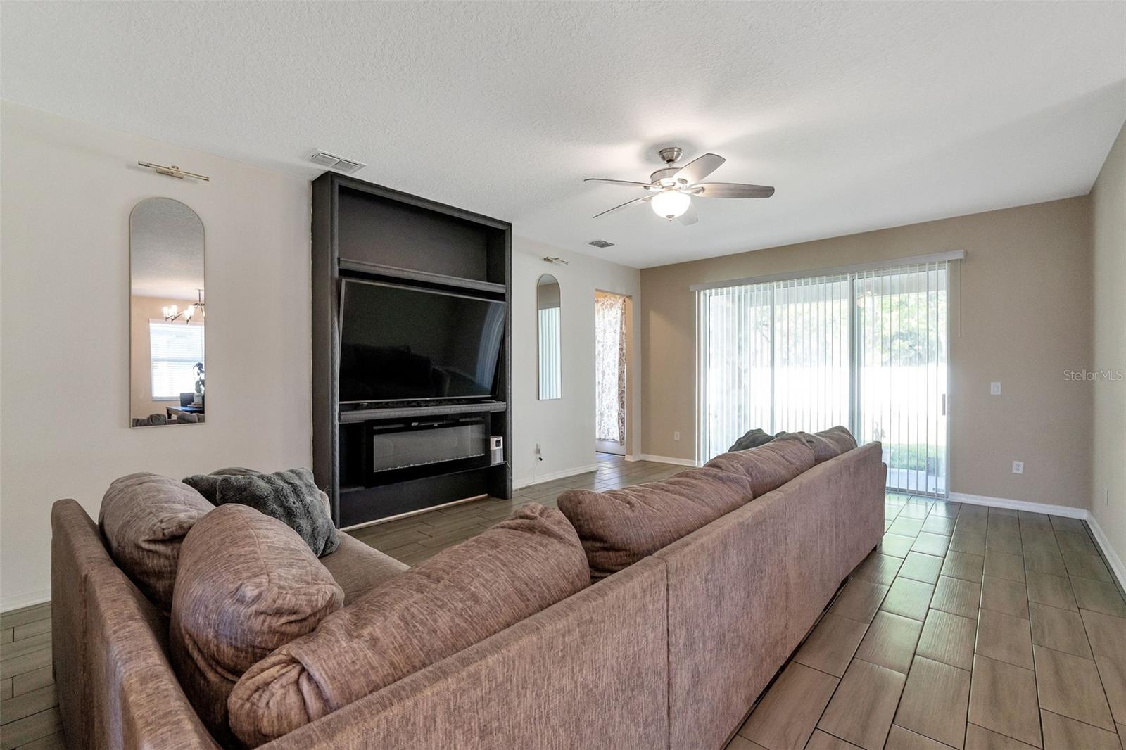 Living room with built in and oversized sliding glass doors