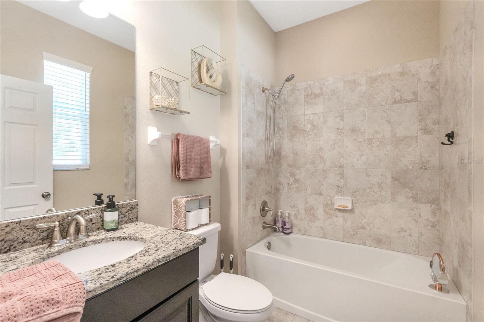 Downstairs bathroom--connected to bedroom via hallway with a door to the back yard.