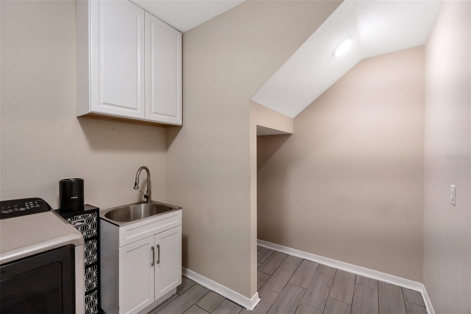 Laundry room and storage under the stairs