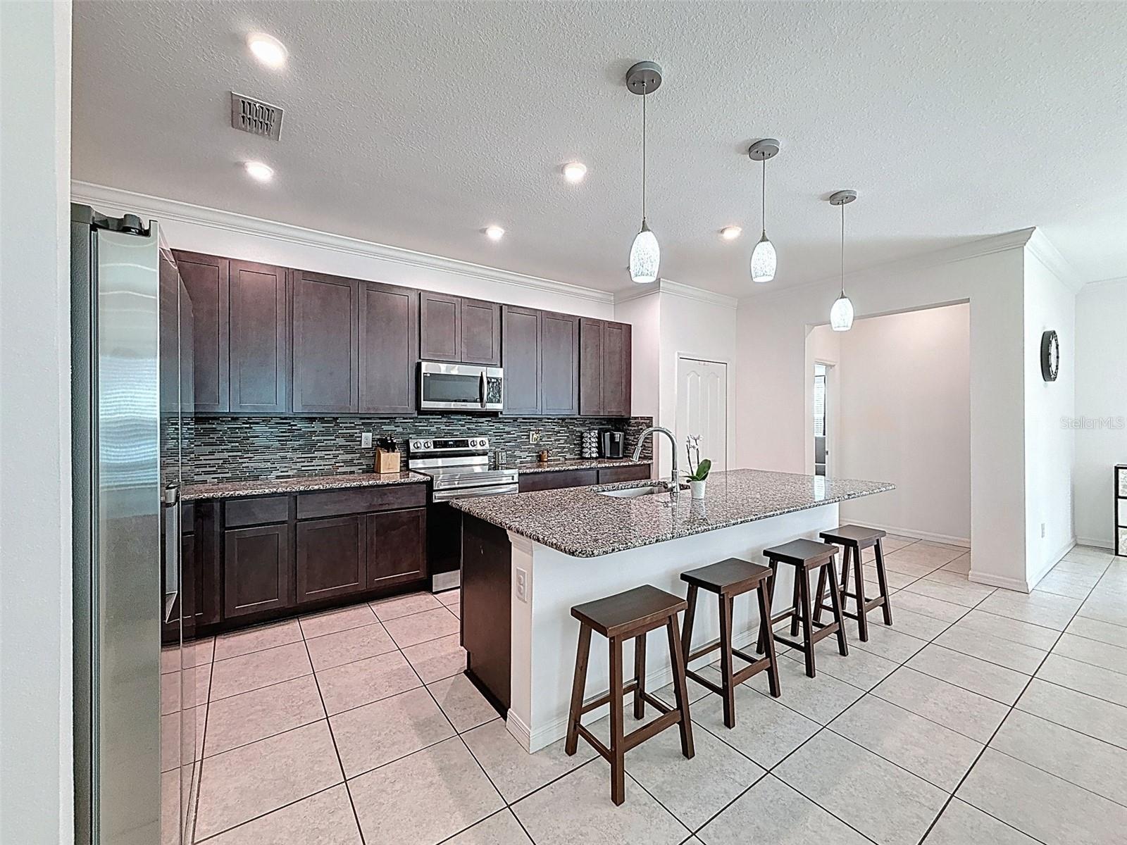 Expansive kitchen anchored by oversized island seating four