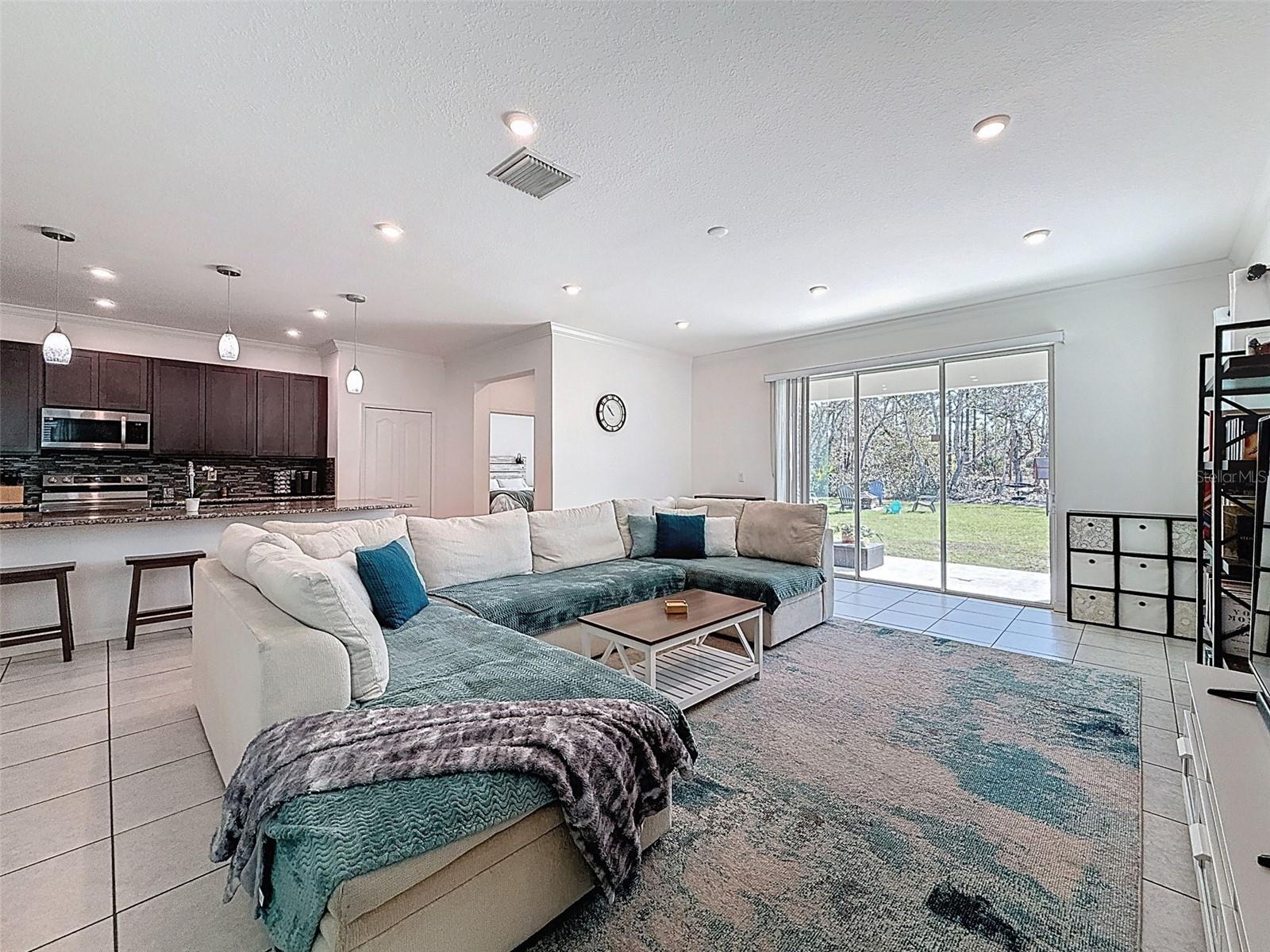 Sliding glass doors open to backyard living