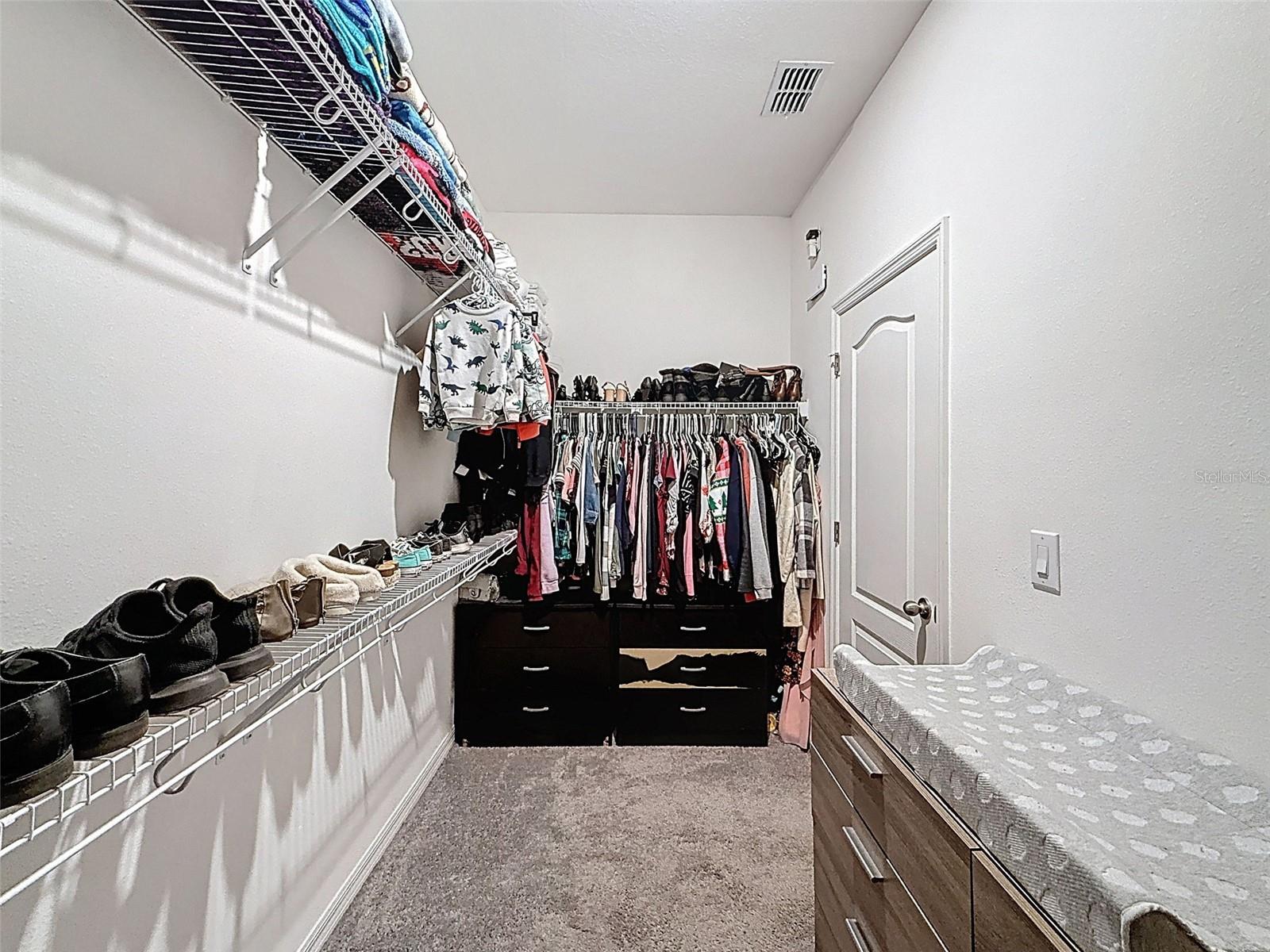 Generous walk-in closet designed for organized living