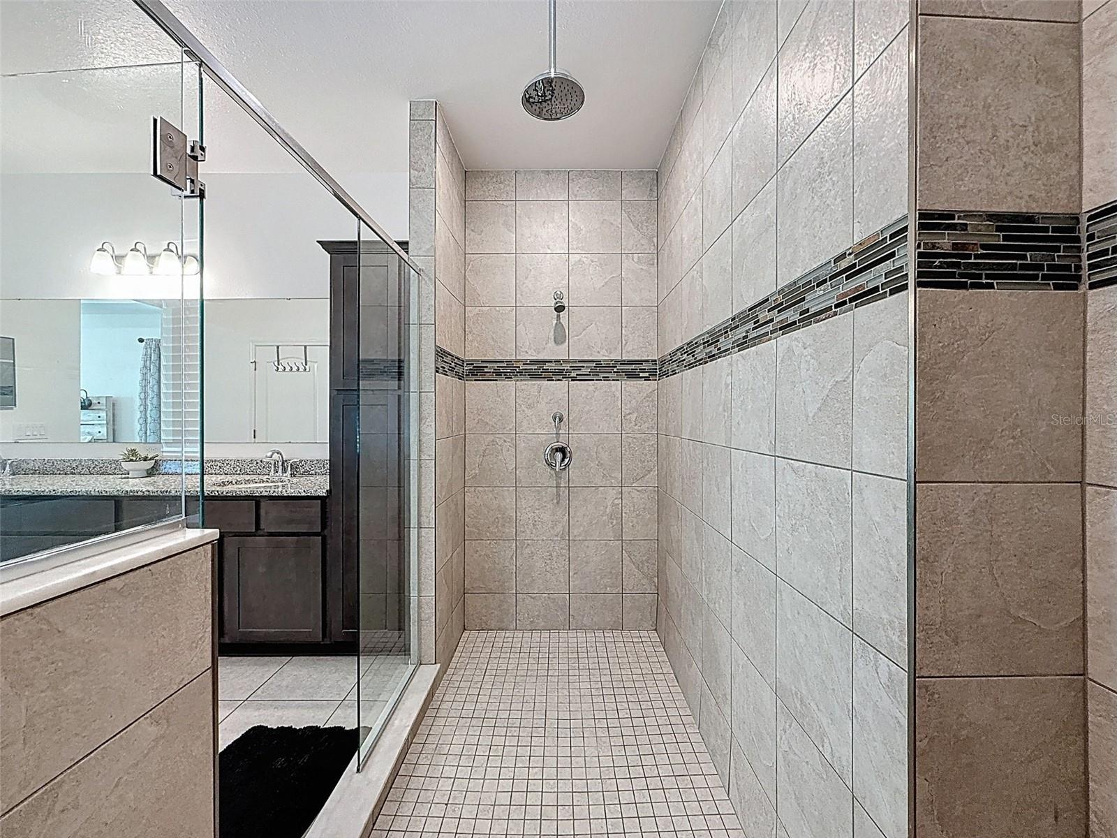 Spa-style shower featuring rainfall and dual fixtures