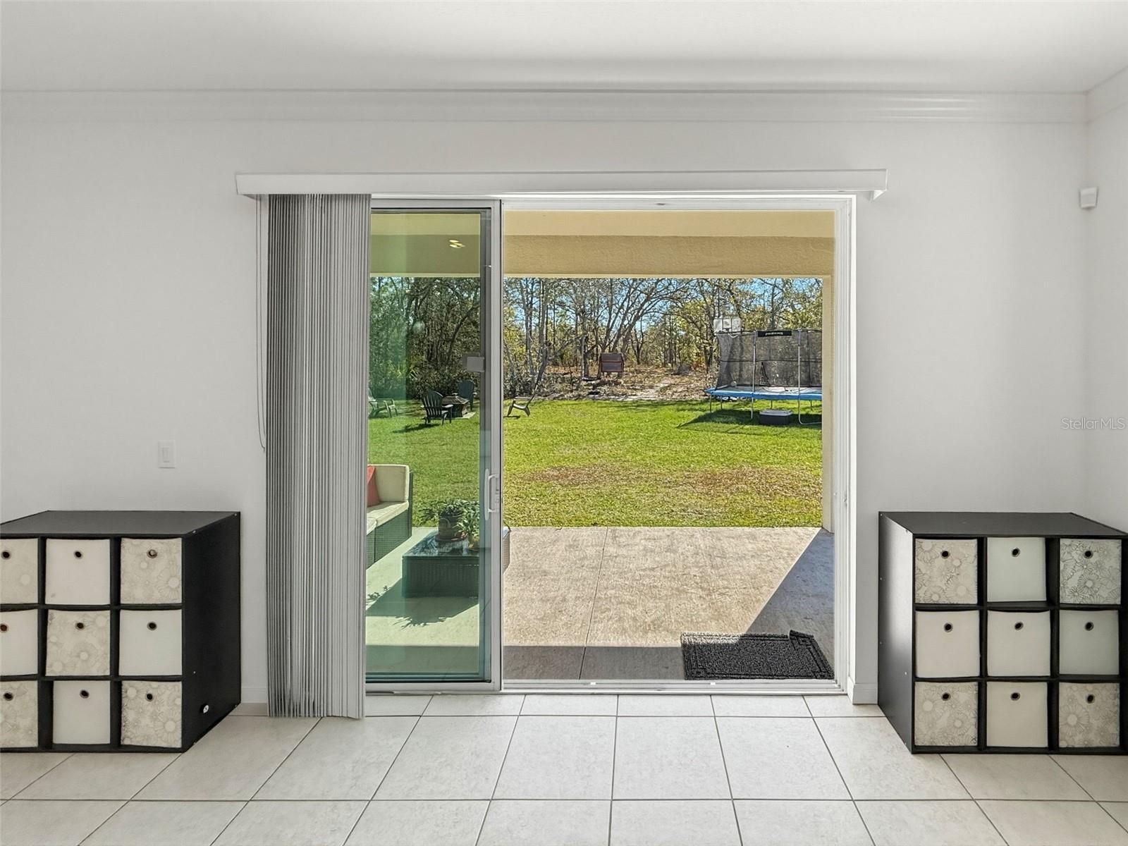 Now lets head out these sliders located off the living area to the backyard