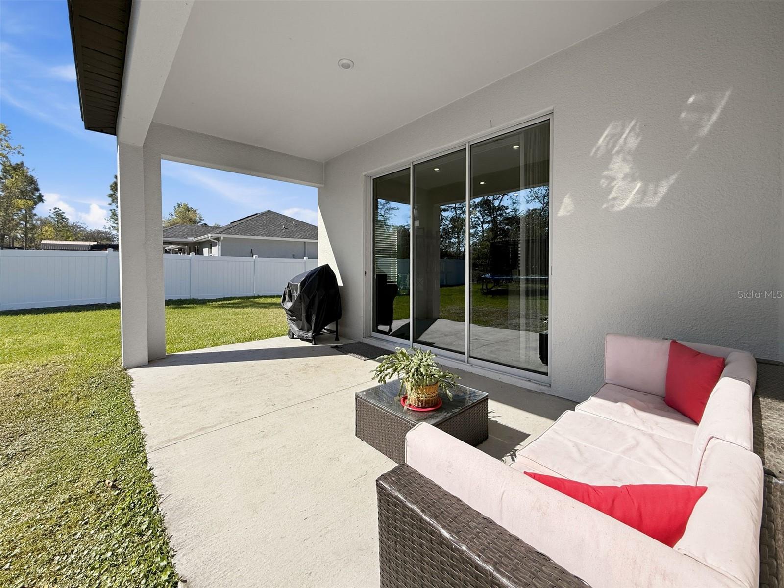 Covered patio with space for grilling and lounging