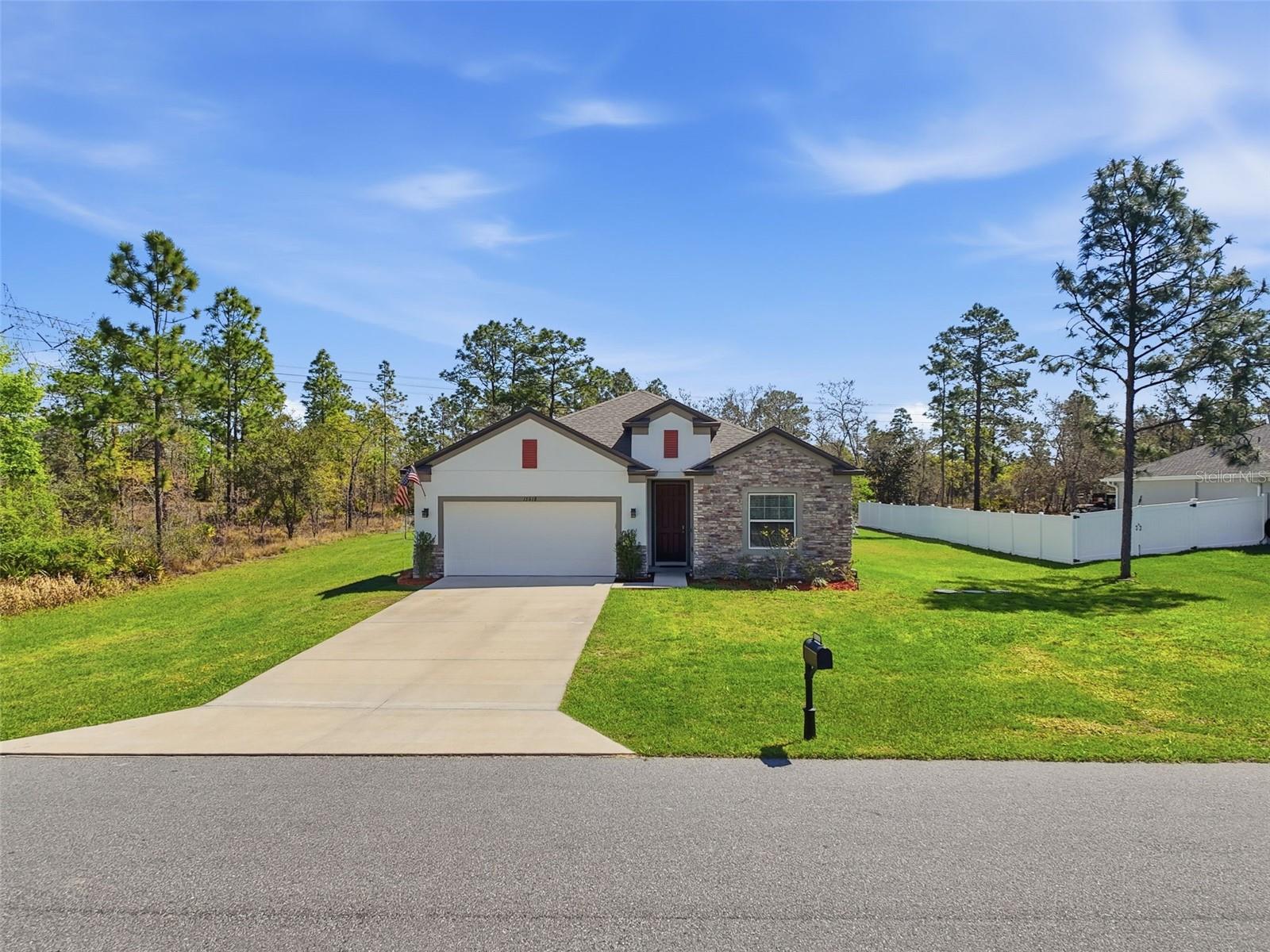 Paved road access with peaceful wooded backdrop