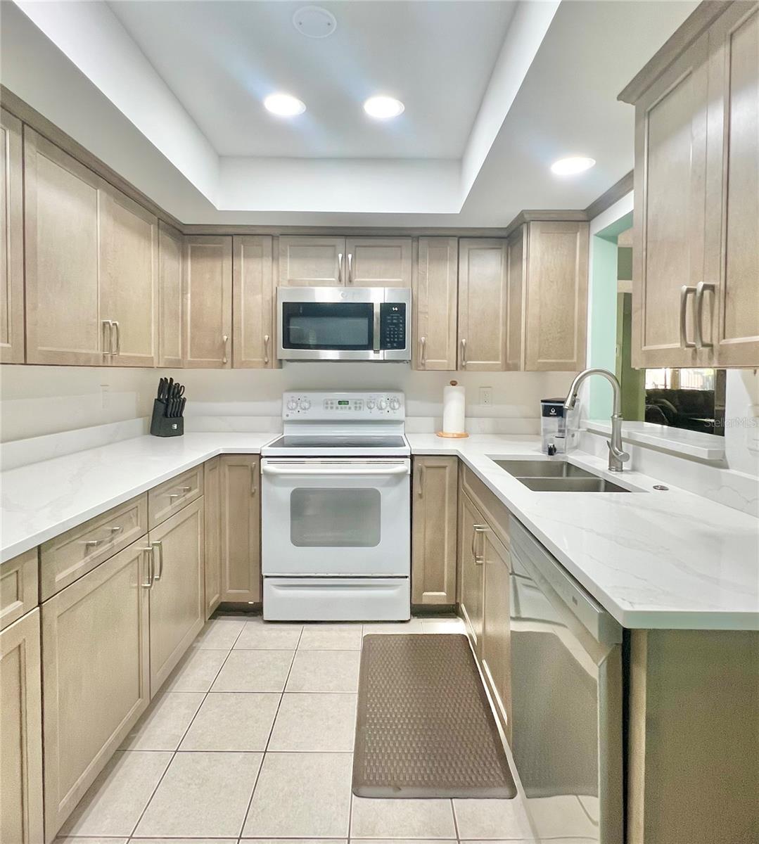 Kitchen with newer appliances and recessed can lights