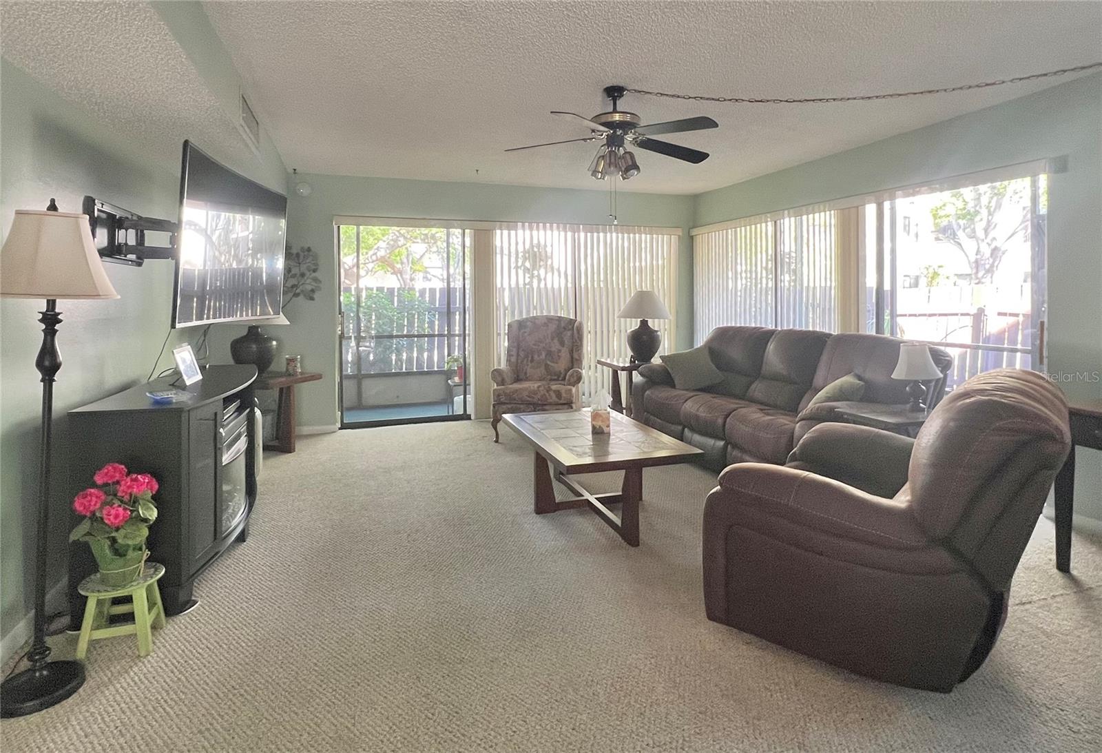 Living room with sliders completely around the perimiter to the screen Lanai