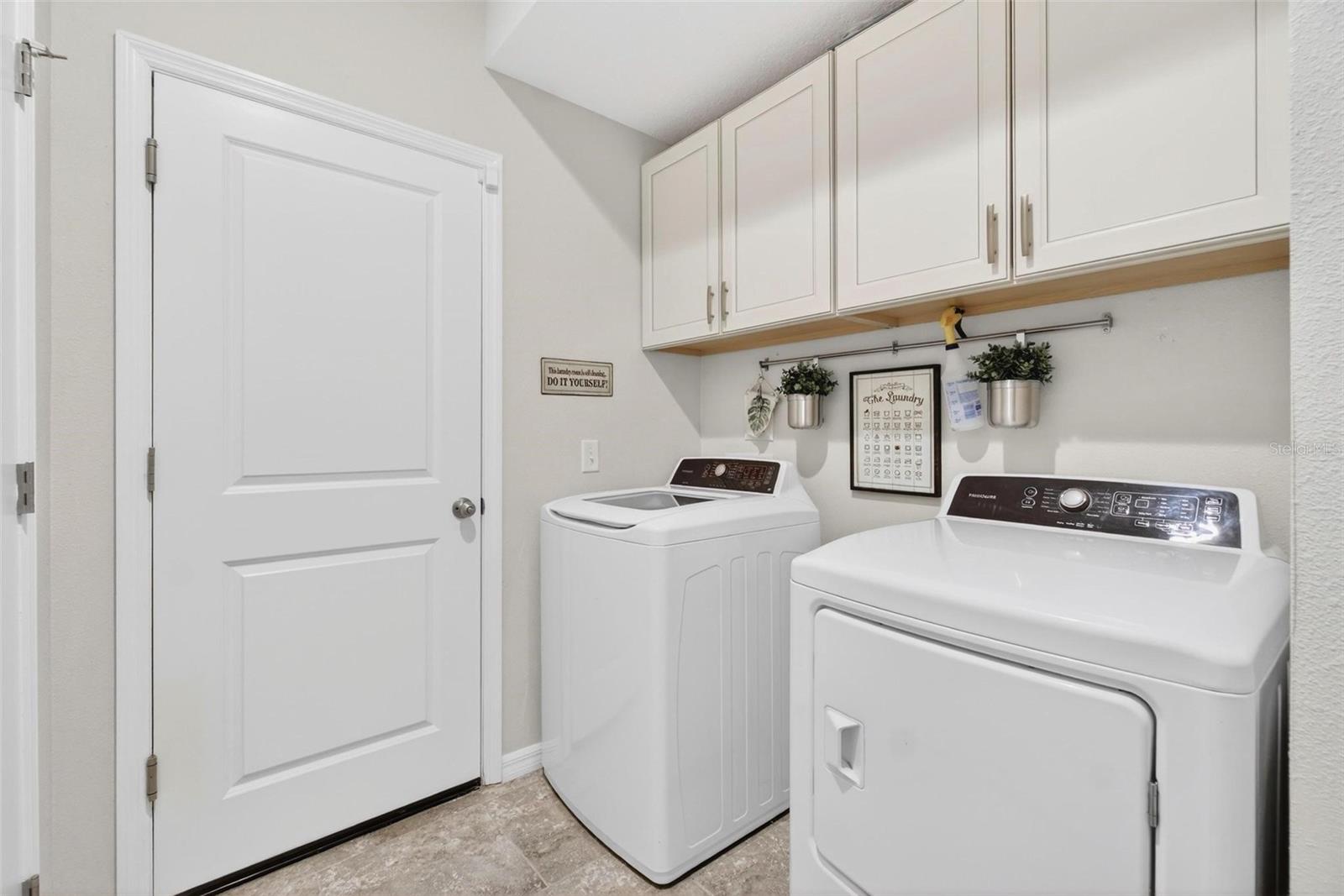 1st Floor Laundry /w storage cabinetry & Garage Entry.