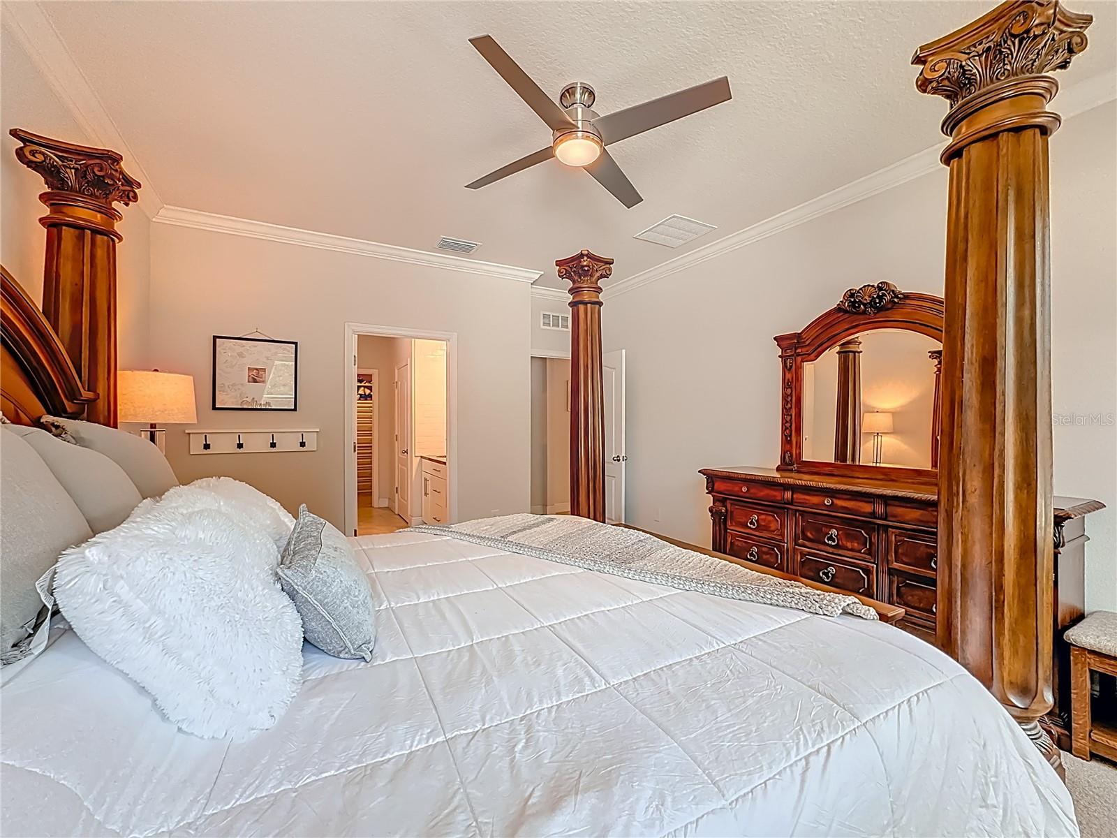 Spacious primary suite featuring en-suite bathroom & oversized custom walk-in closet