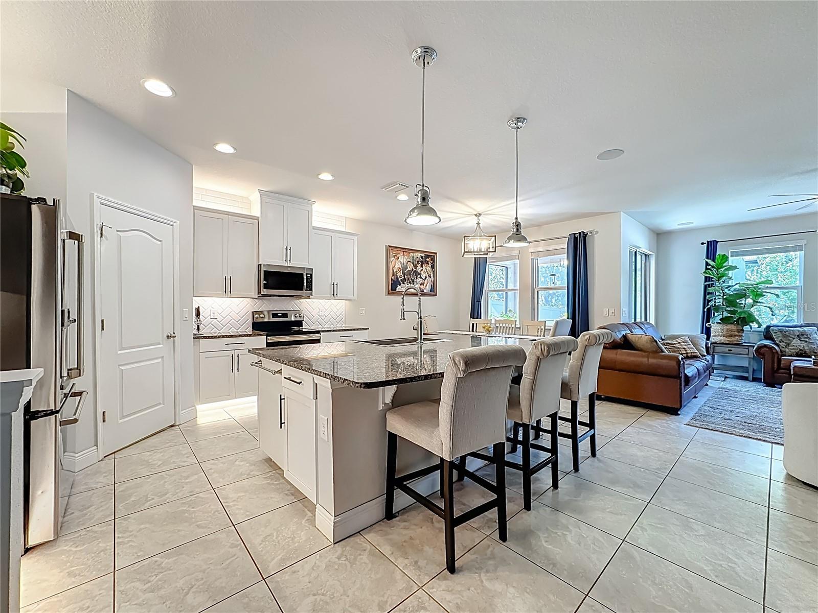 Bright open-concept kitchen with large island & stylish finishes