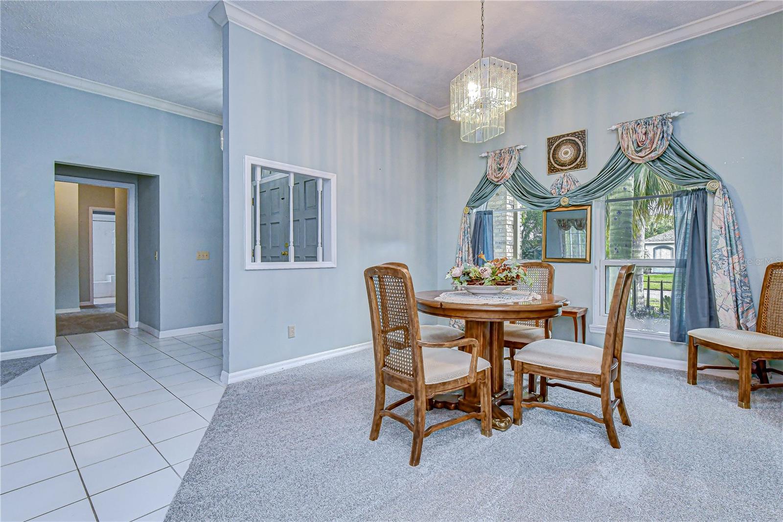 Elegant dining room with soaring ceiling.