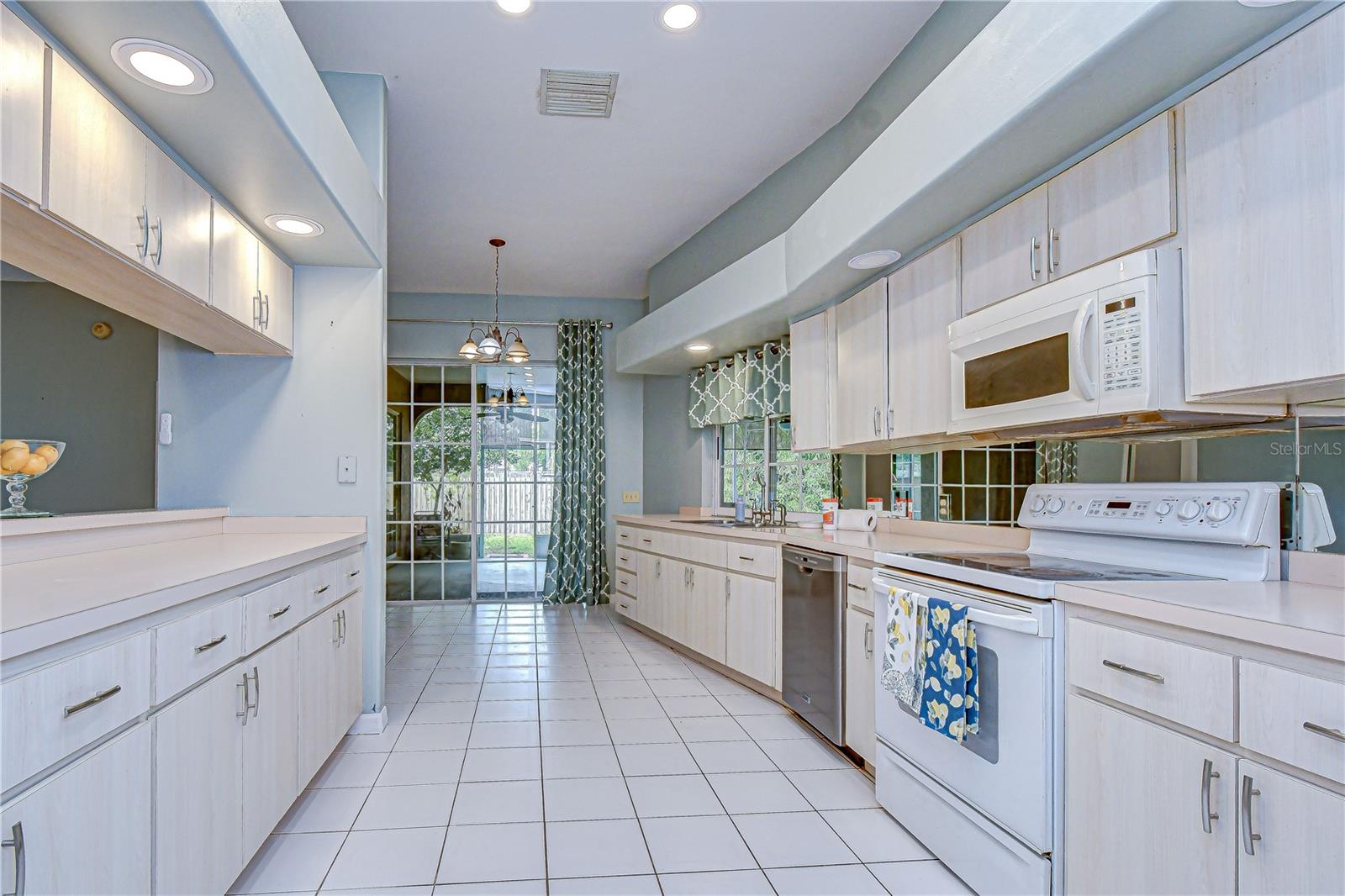 Bright eat-in kitchen with abundant cabinetry.