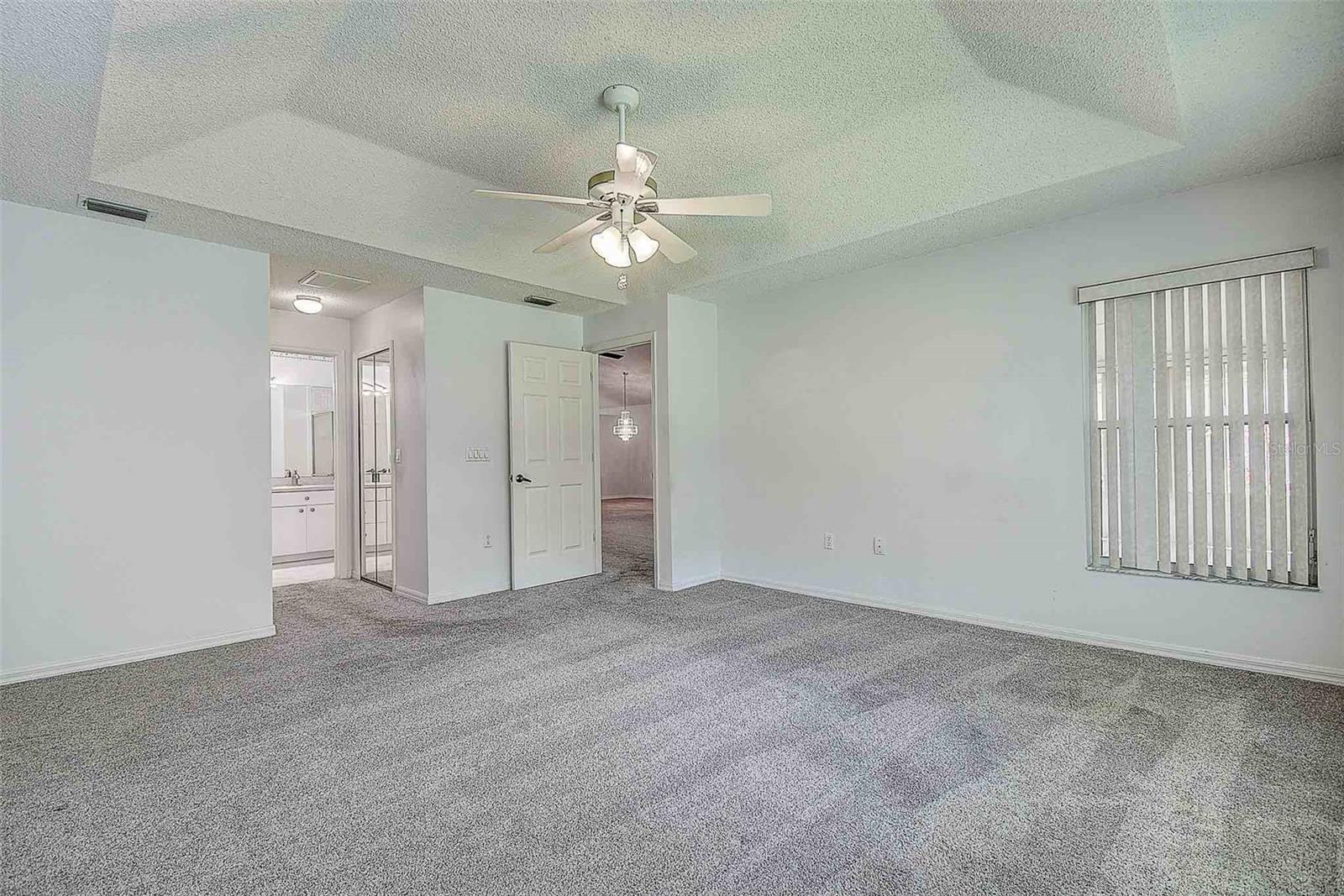 Primary bedroom with side window, dual walk in closets with en suite.