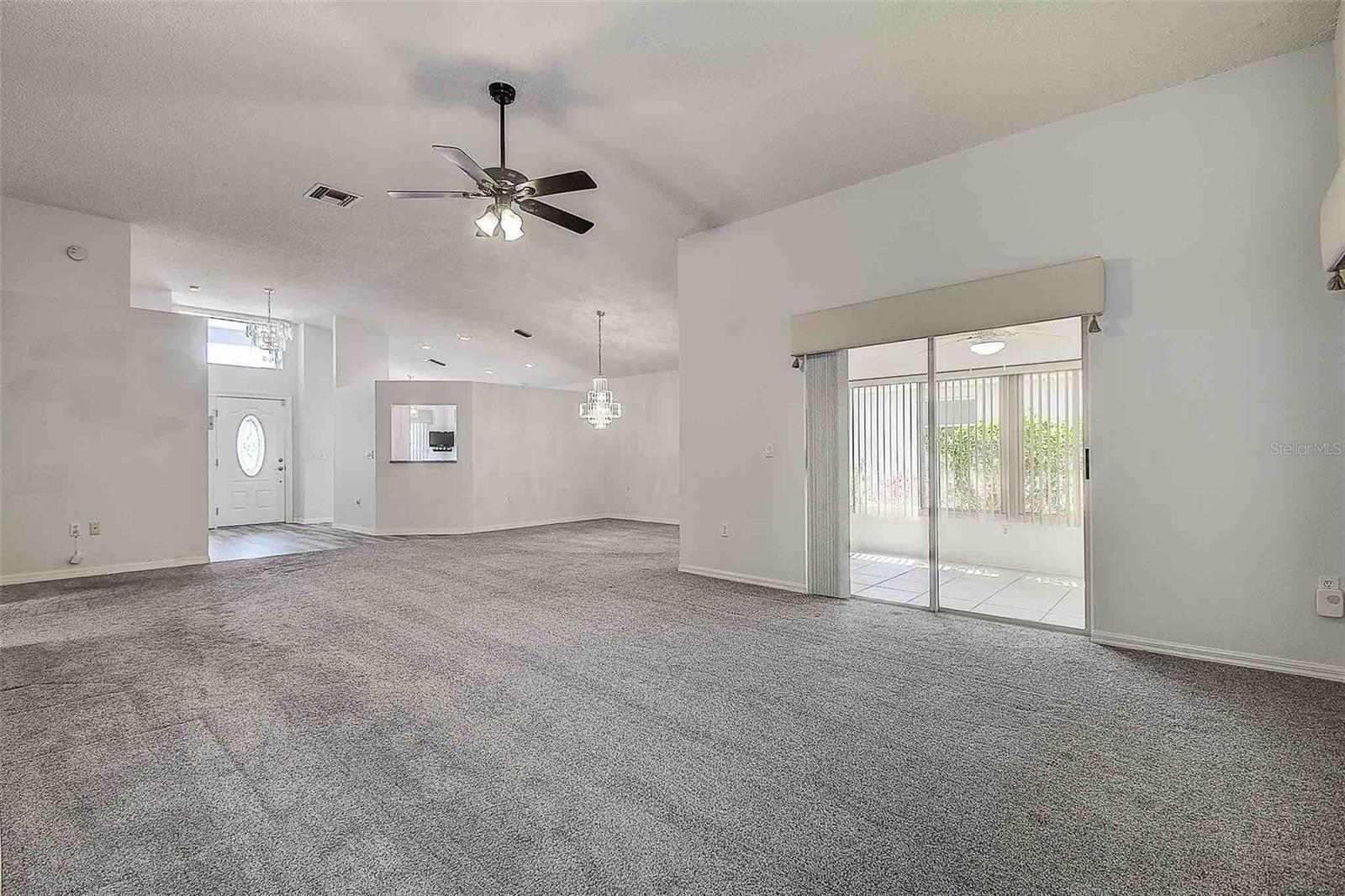 View from primary suite of great room, dining and enclosed lanai.