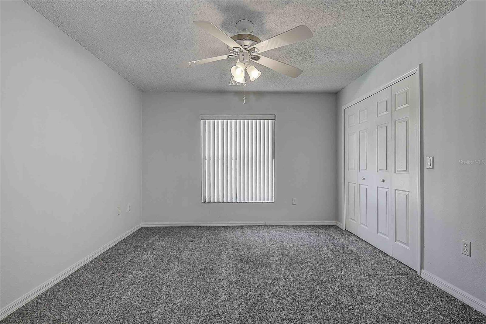 Third bedroom, versatile as an office or den with built in closet and ceiling fan.