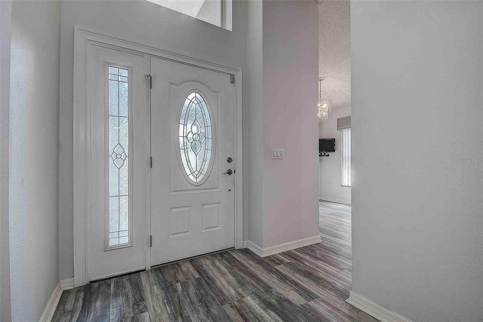 Inviting foyer with new leaded glass accent entry door and sidelight (2010).