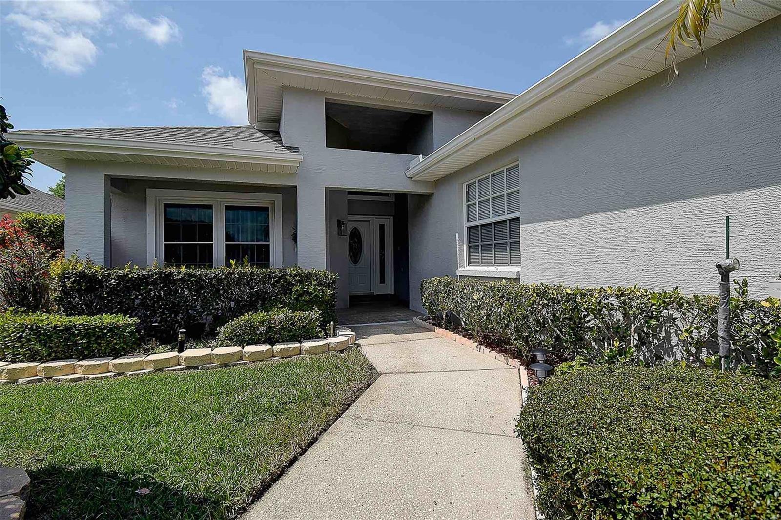 Outdoor gutters, and beautifully manicured landscape with stacked pavers for added design!