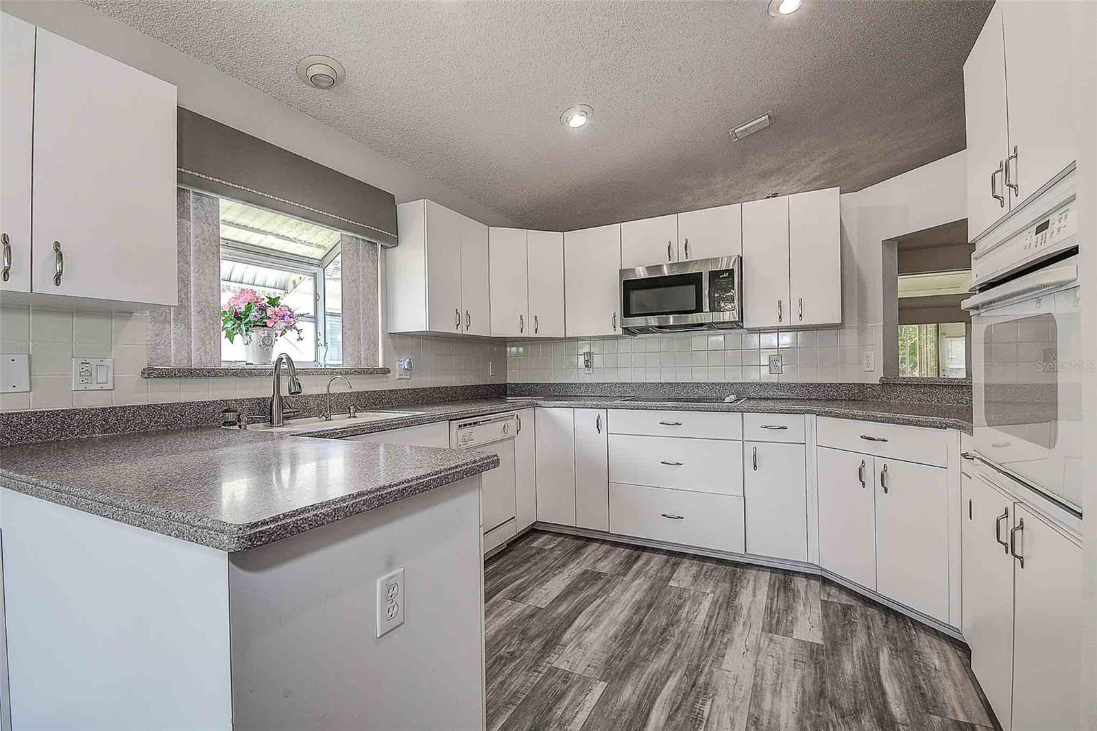 Enjoy cooking with all GE stainless steel kitchen appliances, ample countertop and cabinet space.