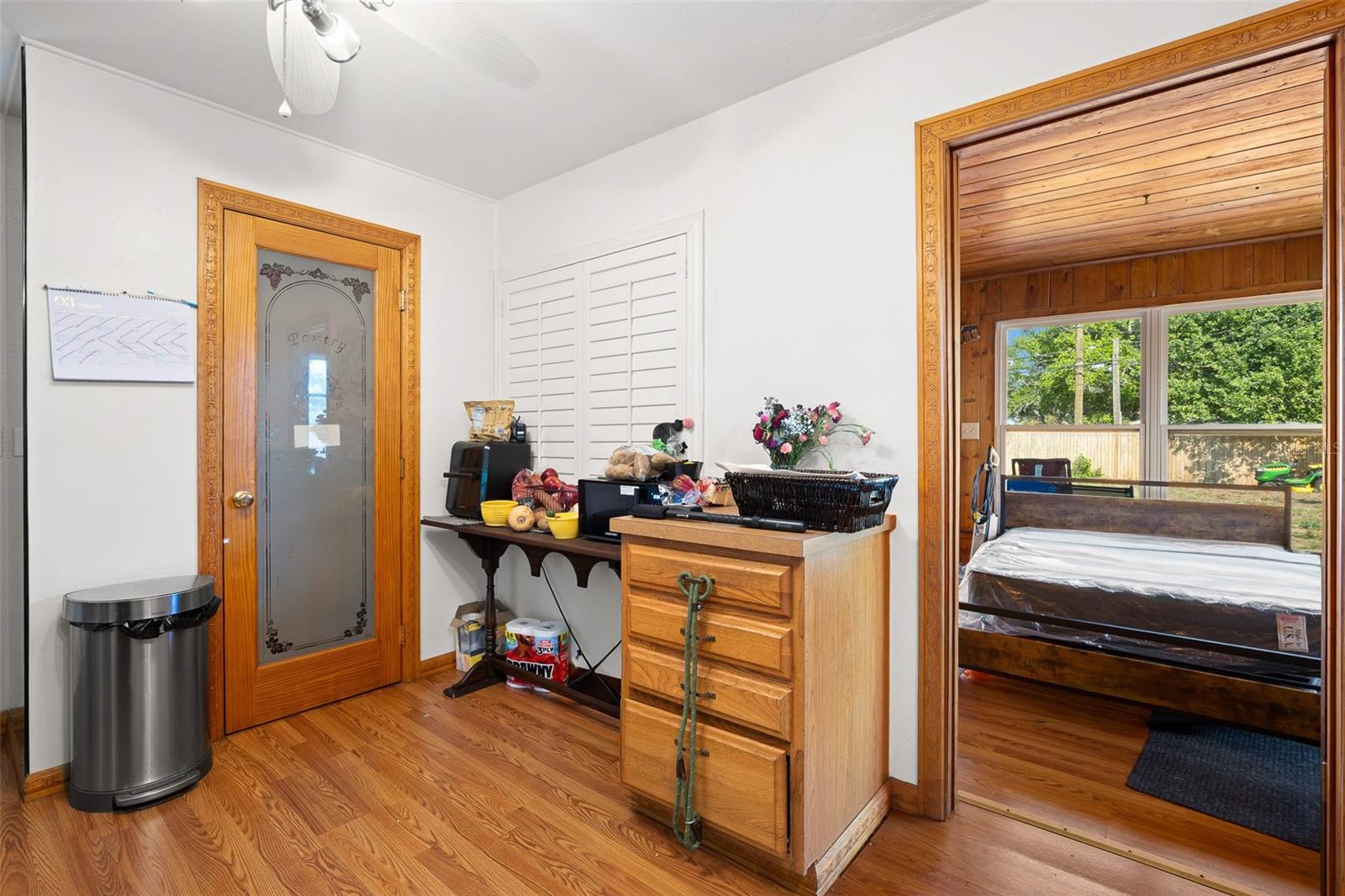The kitchen features a walk-in pantry, wood look flooring, a ceiling fan with light kit.