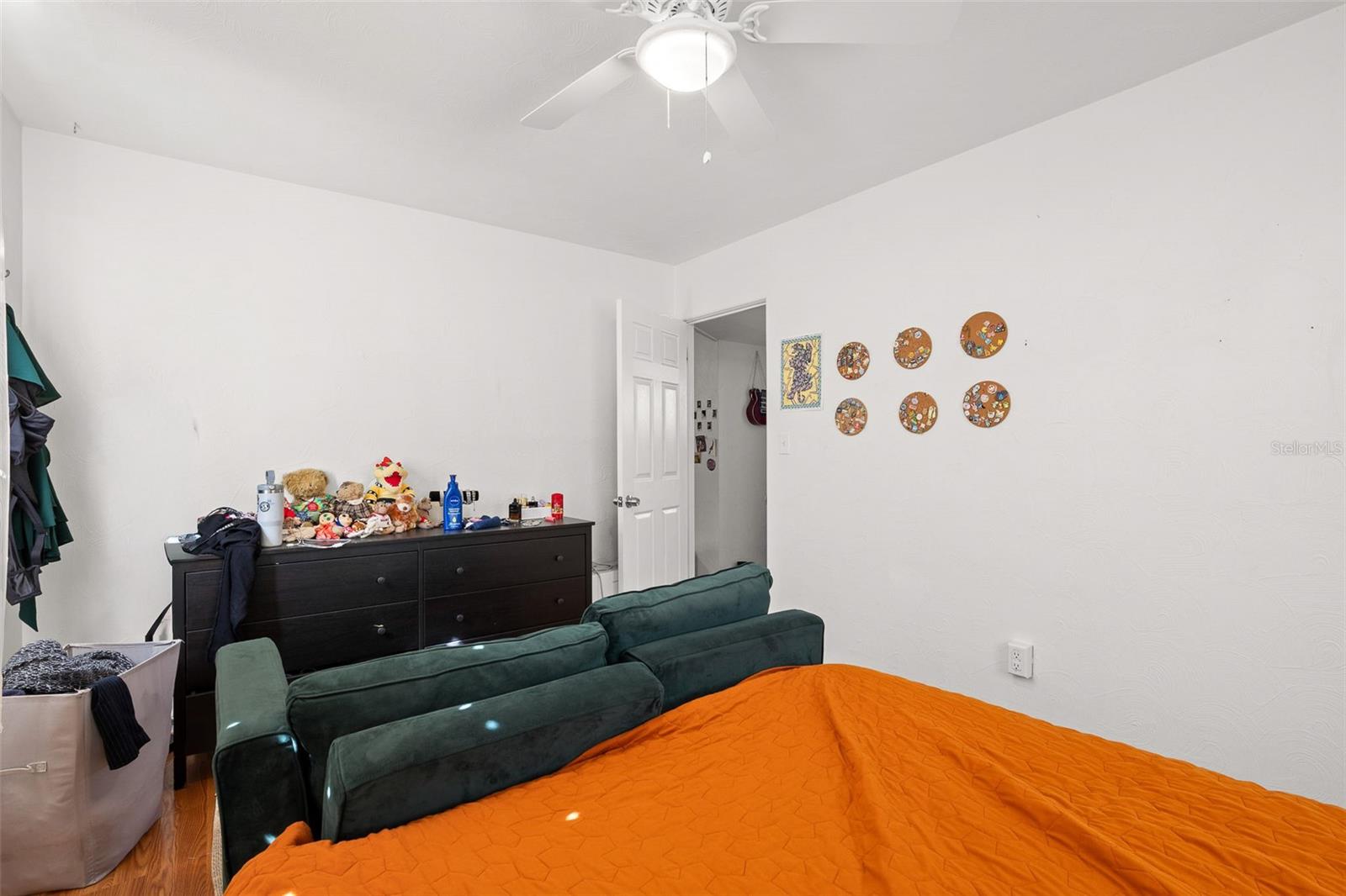 Primary bedroom featuring wood-look flooring and a versatile layout, offering plenty of space for both rest and everyday living.